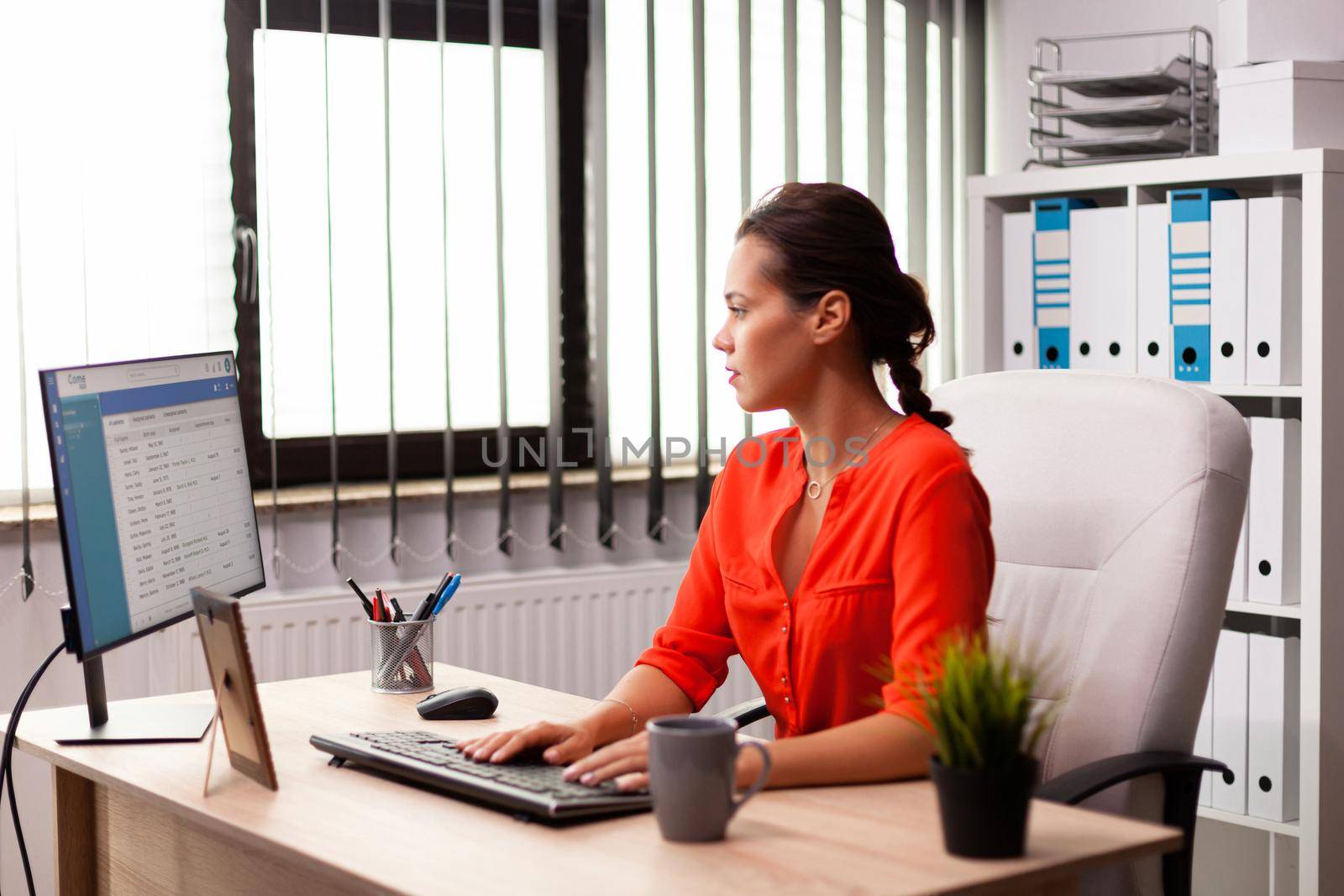 Freelancer corporate executive businesswoman working on marketing strategy. Successful concentrated employer with busy carreer sitting at desk in office using modern pc.