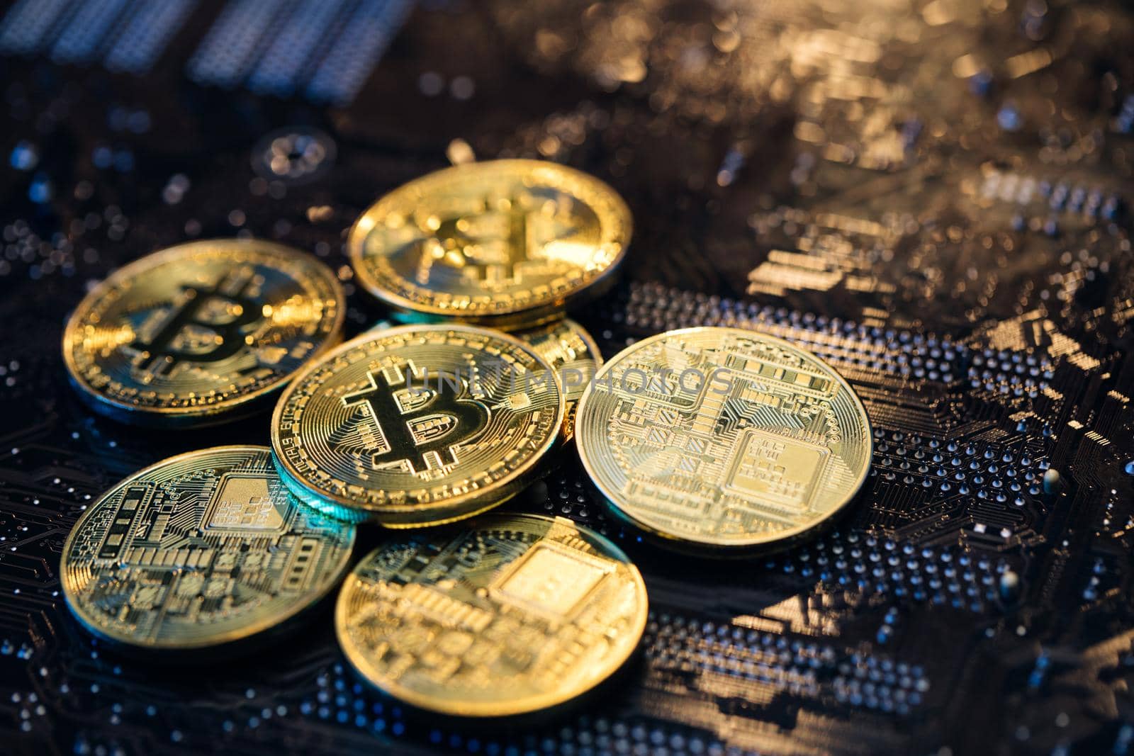 Blockchain technology, bitcoin mining. Close up shot of Gold Bitcoins coins isolated on motherboard background. Crypto currency, bitcoin. BTC, Bit Coin by uflypro