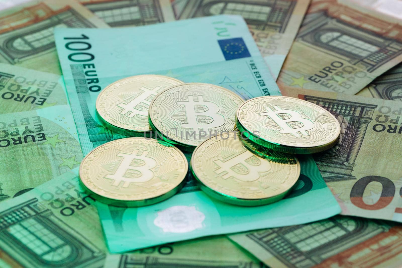 Coin with symbol of cryptocurrency of bitcoin lies on real banknotes of European Union, euro, new money, exchange of digital money for euro, gold coin, new economy. Euro banknotes. Euro bills. by uflypro