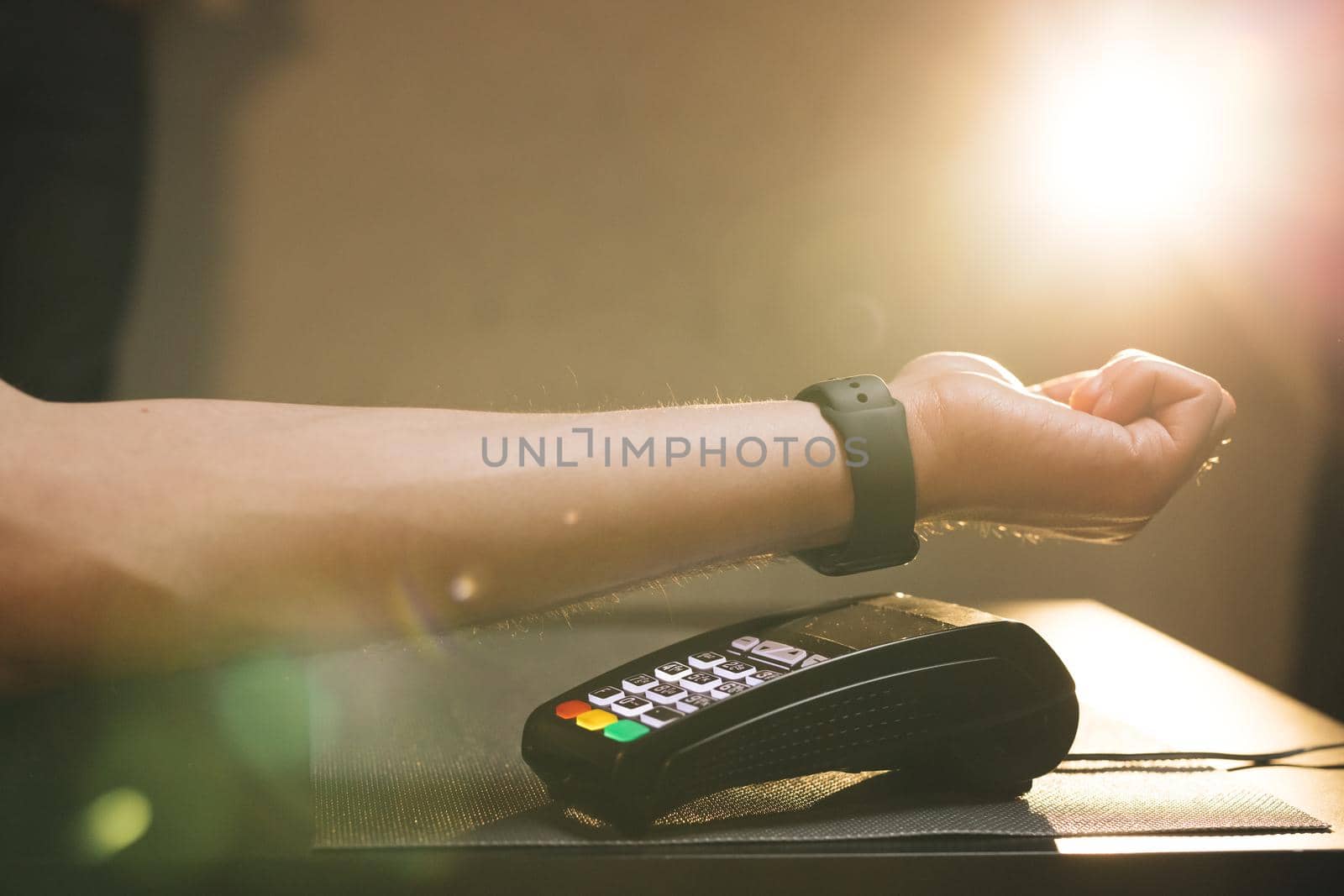 Contactless technology NFC. Consumerism internet online purchases. Man is Paying with a Smart Watch. Person pays in a cafe using an electronic smartwatch.