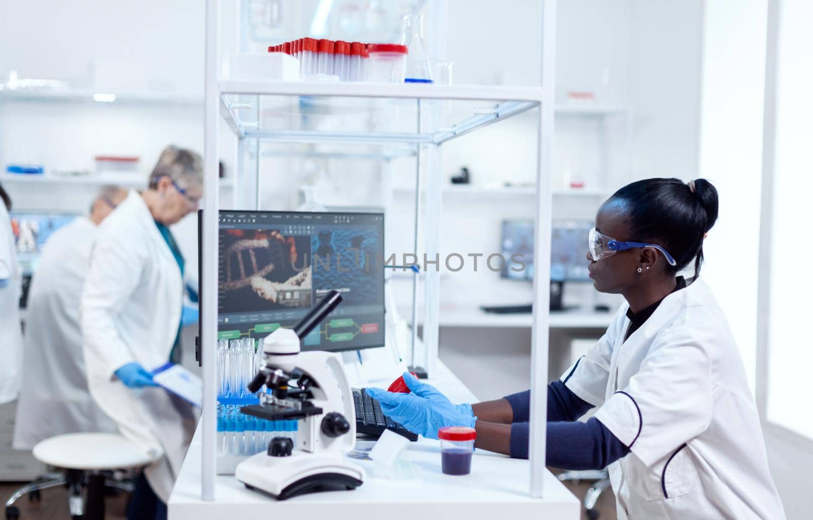 Scientist with african ethnicity conducting virus analysis by DCStudio