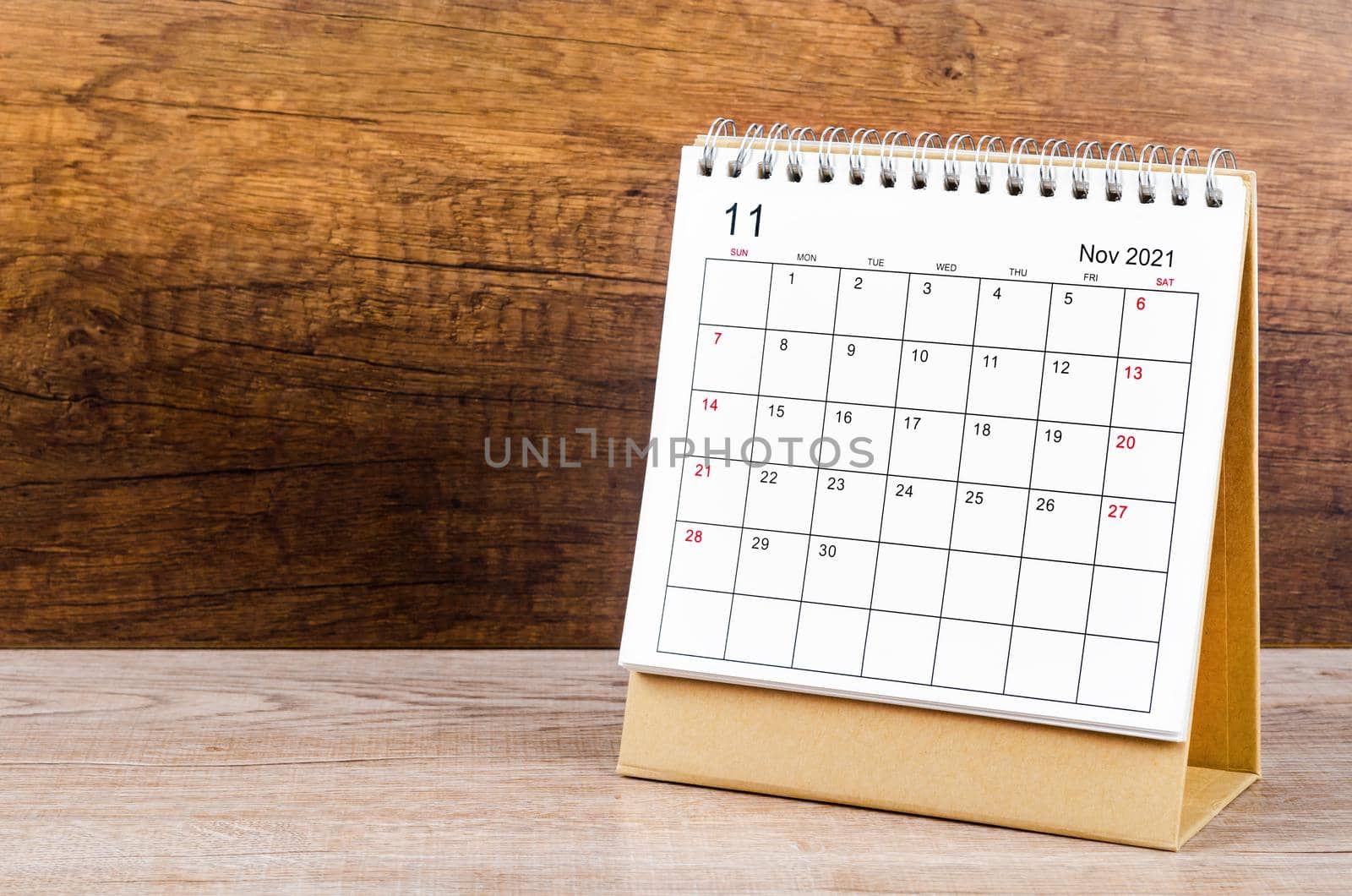 November desk calendar 2021 on wooden background.