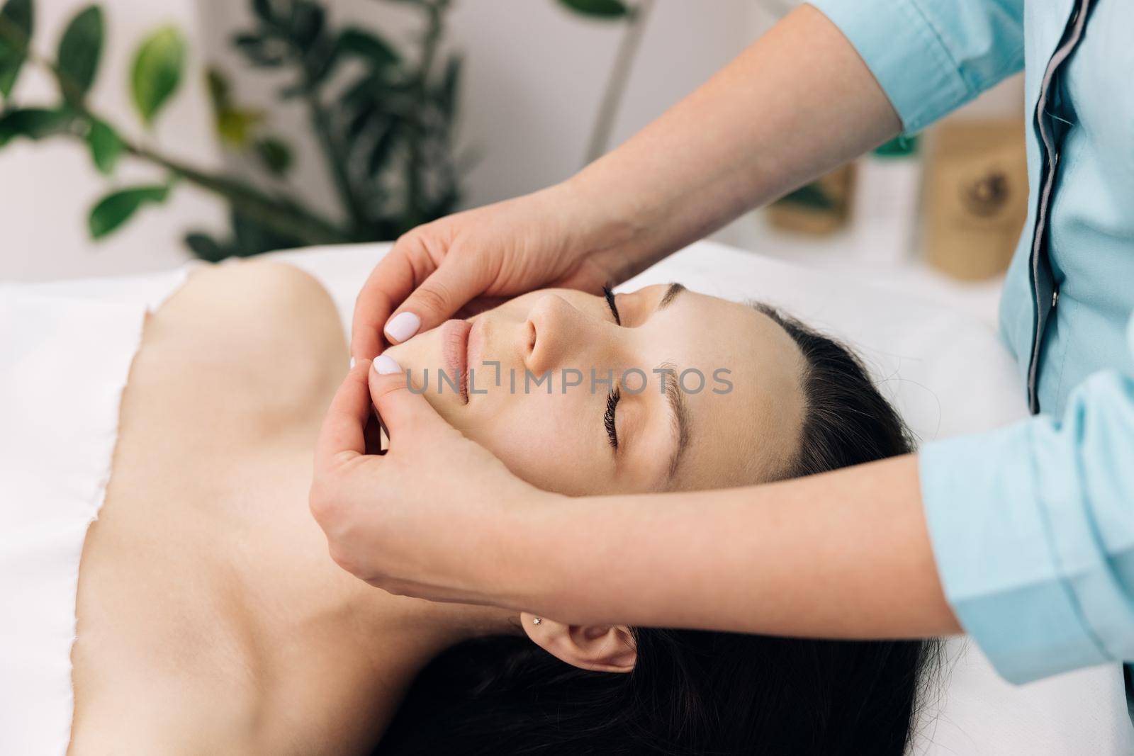 Female enjoying relaxing face massage in cosmetology spa centre. Body care, skin care, beauty treatment. Wellness and beauty salon. Relaxing and health. Spa woman facial massage.