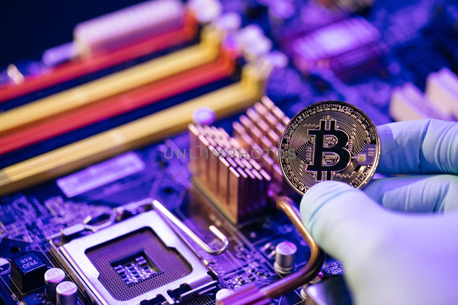 Gold Bitcoin electronic computer processor board. Male man Holding Bitcoin Isolated on motherboard background. Digital Money and Bitcoine Concept