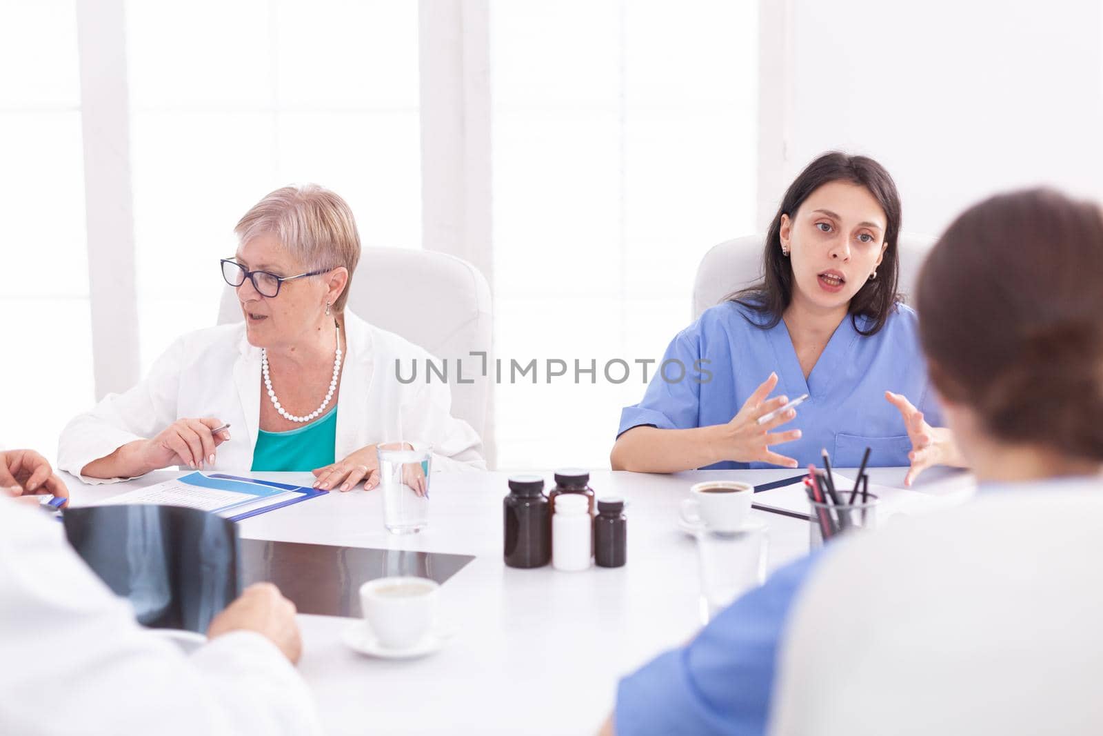 Medical team sitting and discussing by DCStudio