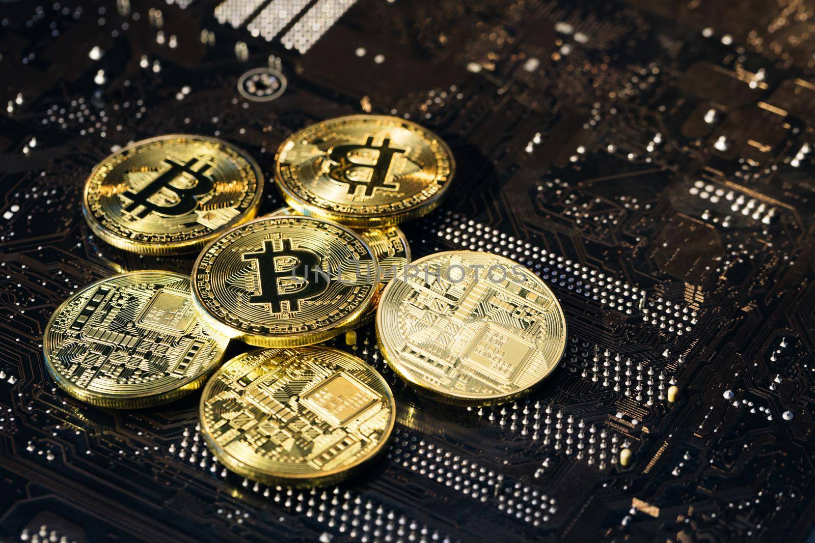 Golden Bitcoins. New virtual money. Mining Golden Bitcoins. Bitcoins coins isolated on motherboard background. Crypto currency, bitcoin. BTC, Bit Coin. Blockchain technology