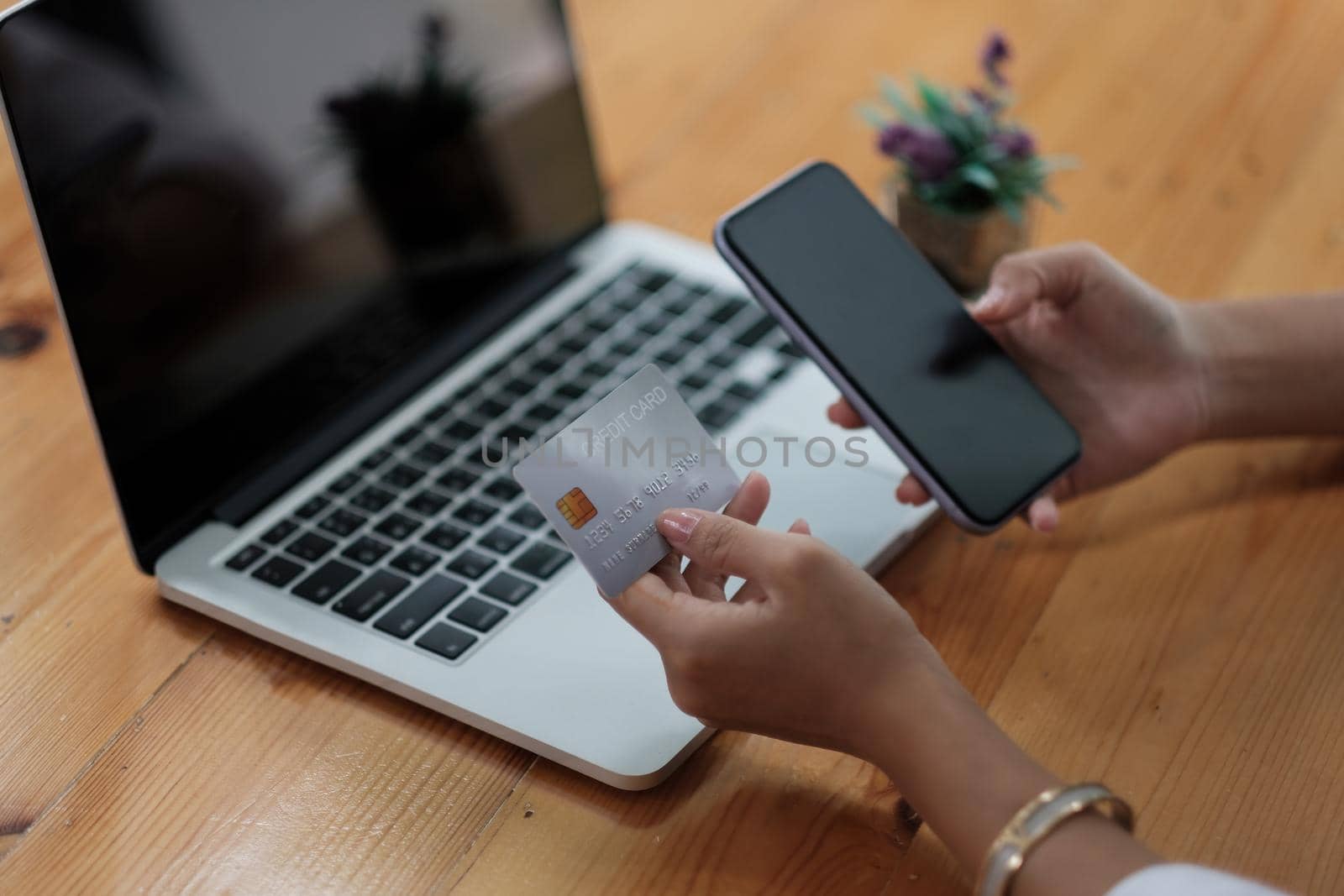 Woman holding credit card and using smartphone at home, businessman shopping online, e-commerce, internet banking, spending money, working from home concept.
