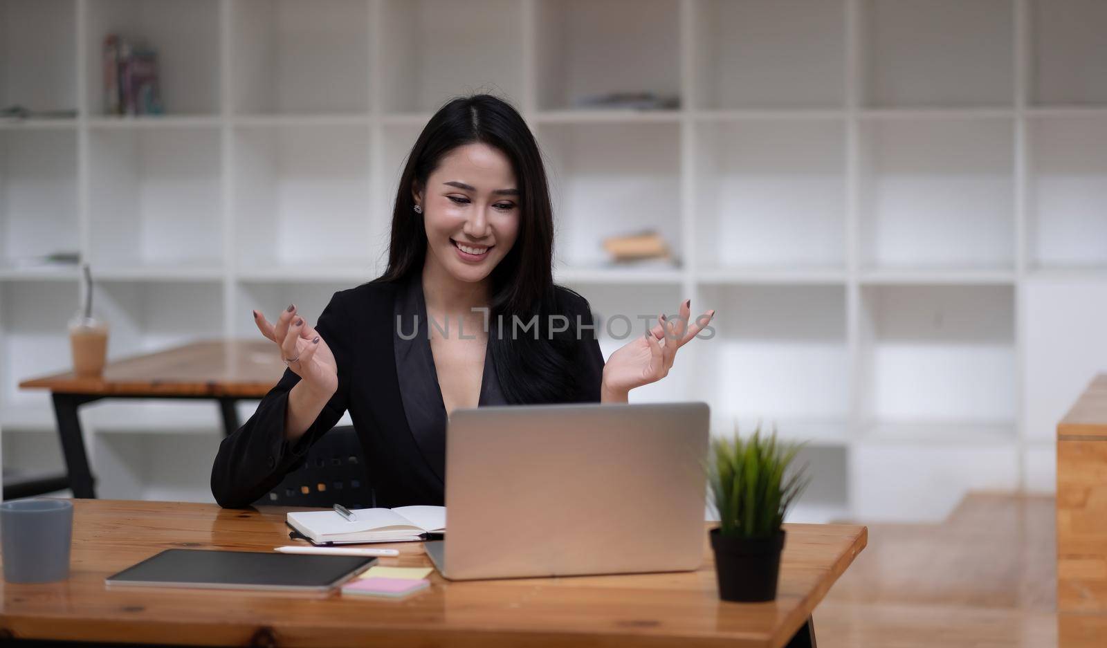 Happy asian woman communicate by video call on computer working from home. Smiling businesswoman talking by video conference, online virtual meeting using computer by nateemee