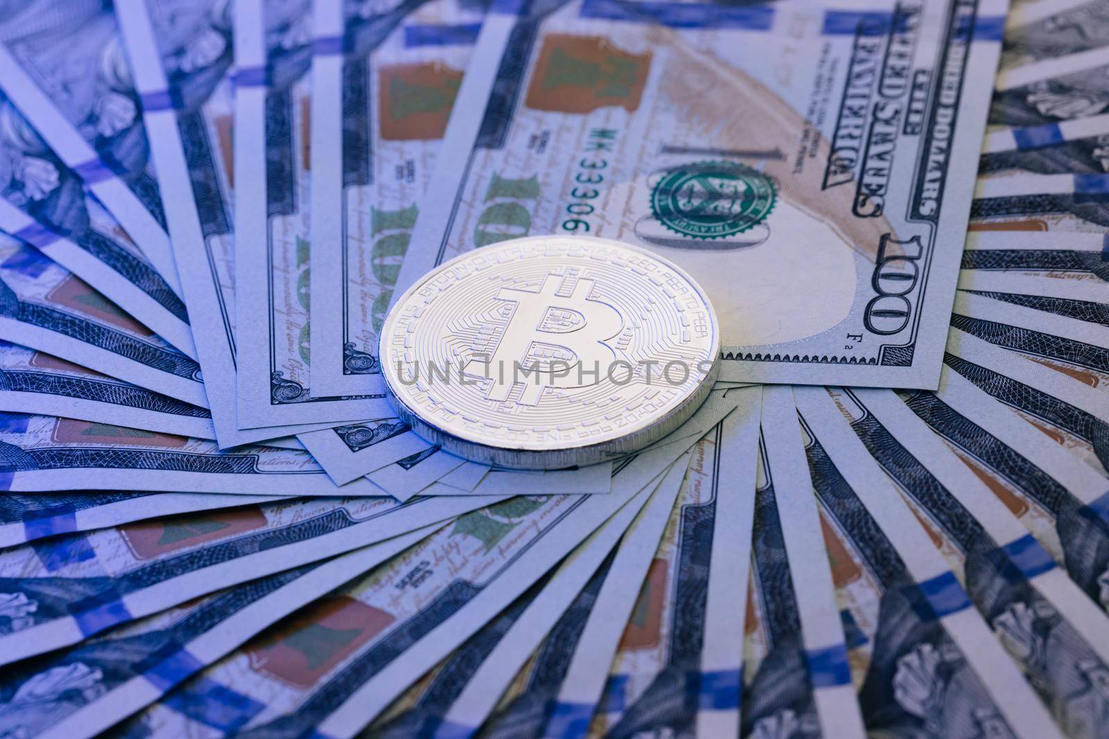 New worldwide virtual internet money with USA banknotes. Bitcoin crypto currency stacked with 100 dollar bills. Diferent physical metal currency over 100 dollar bill of United States.