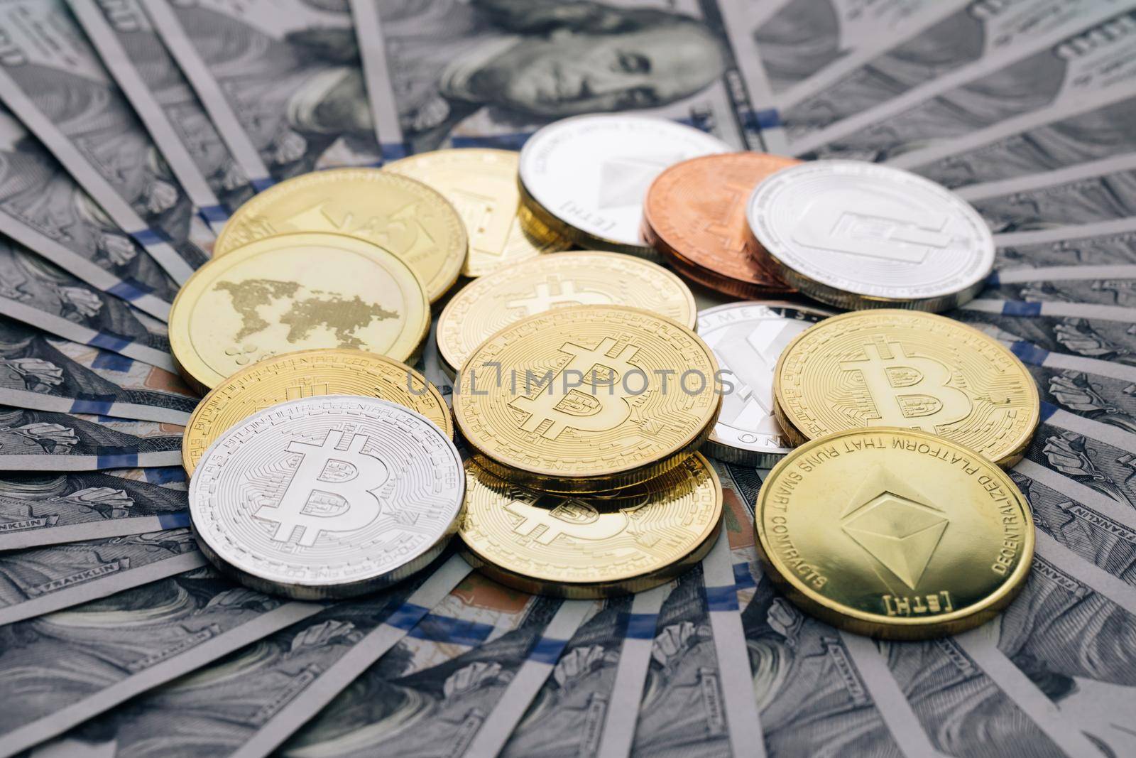 Diferent physical metal currency rotating over 100 dollar bill of United States. New worldwide virtual internet money with USA banknotes. Digital coin cyberspace, cryptocurrency. Online payment by uflypro