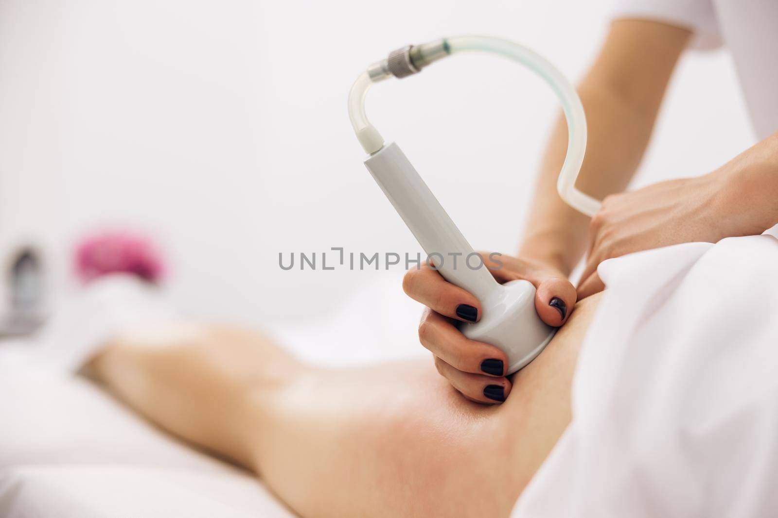 Woman getting Vacuum massage procedure in a beauty salon. Anticellulite and lifting therapy with hardware cosmetology. Woman getting rf-lifting. Hardware cosmetology.