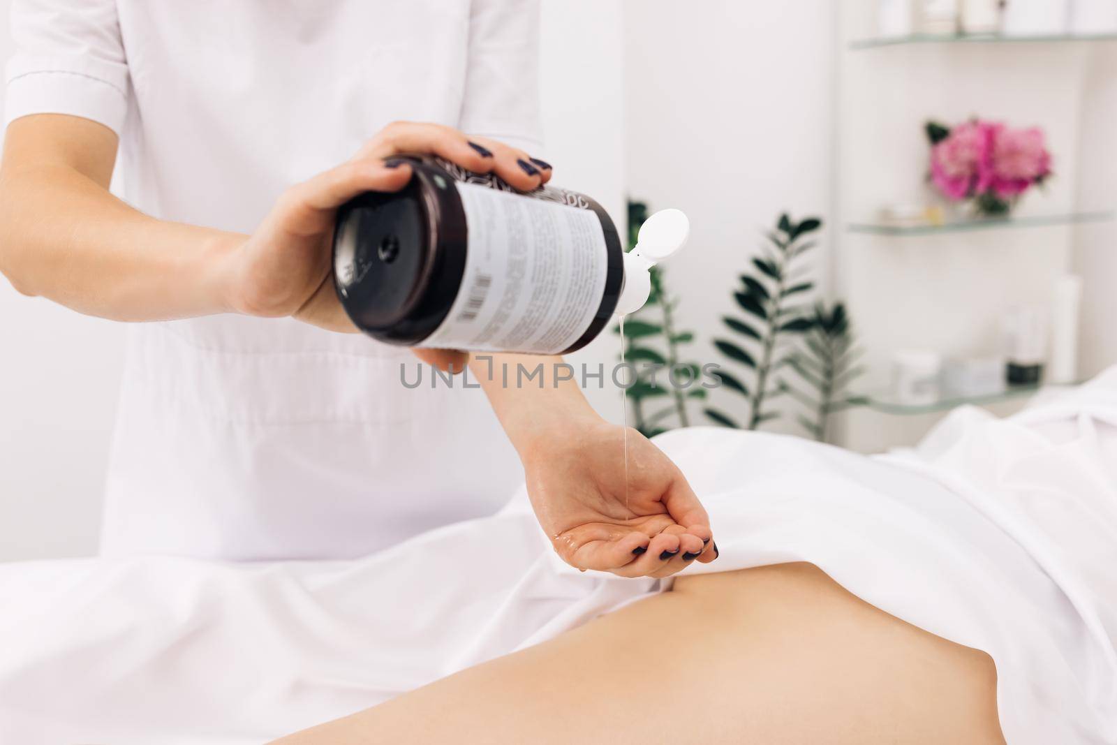 Creme treatment on woman legs with hydrating lotion. Preventing dry skin on female body parts close-up. Therapeutic massage of the female leg. Woman hands doing professional massage.