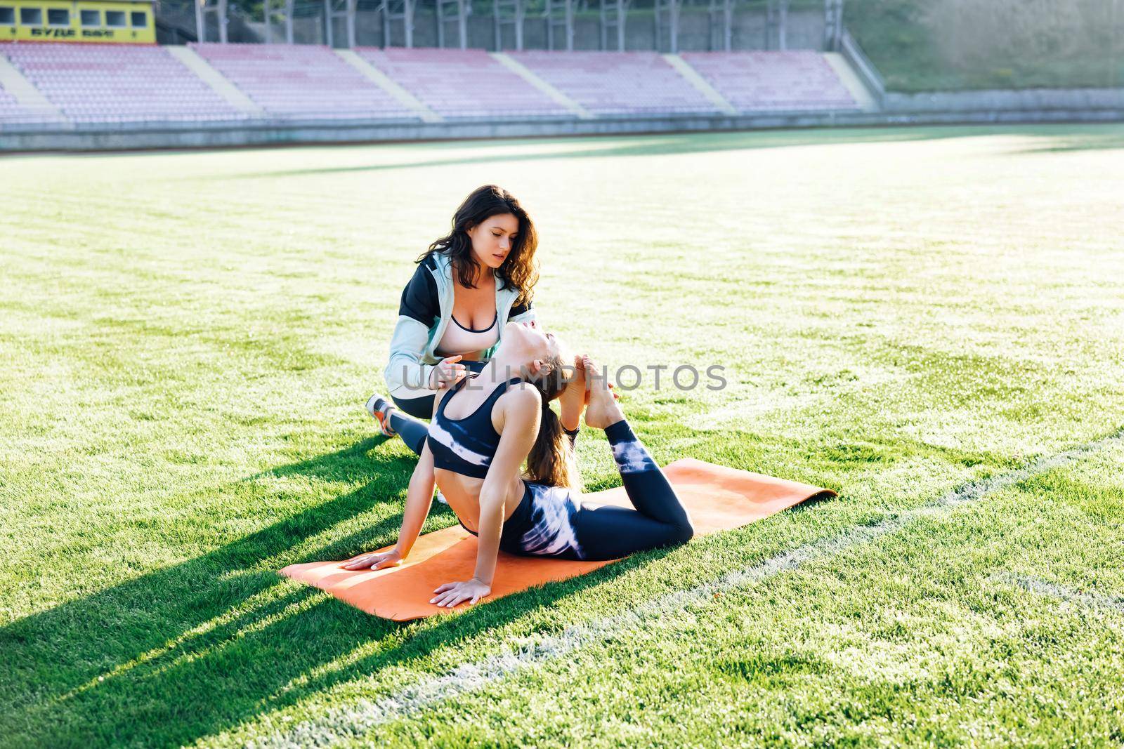 Young girl doing exercises under physiotherapist supervision. Patient Uses Physical Therapy to Recover from Surgery and Increase Mobility. The Doctor Works on Specific Muscle Groups or Joints by uflypro