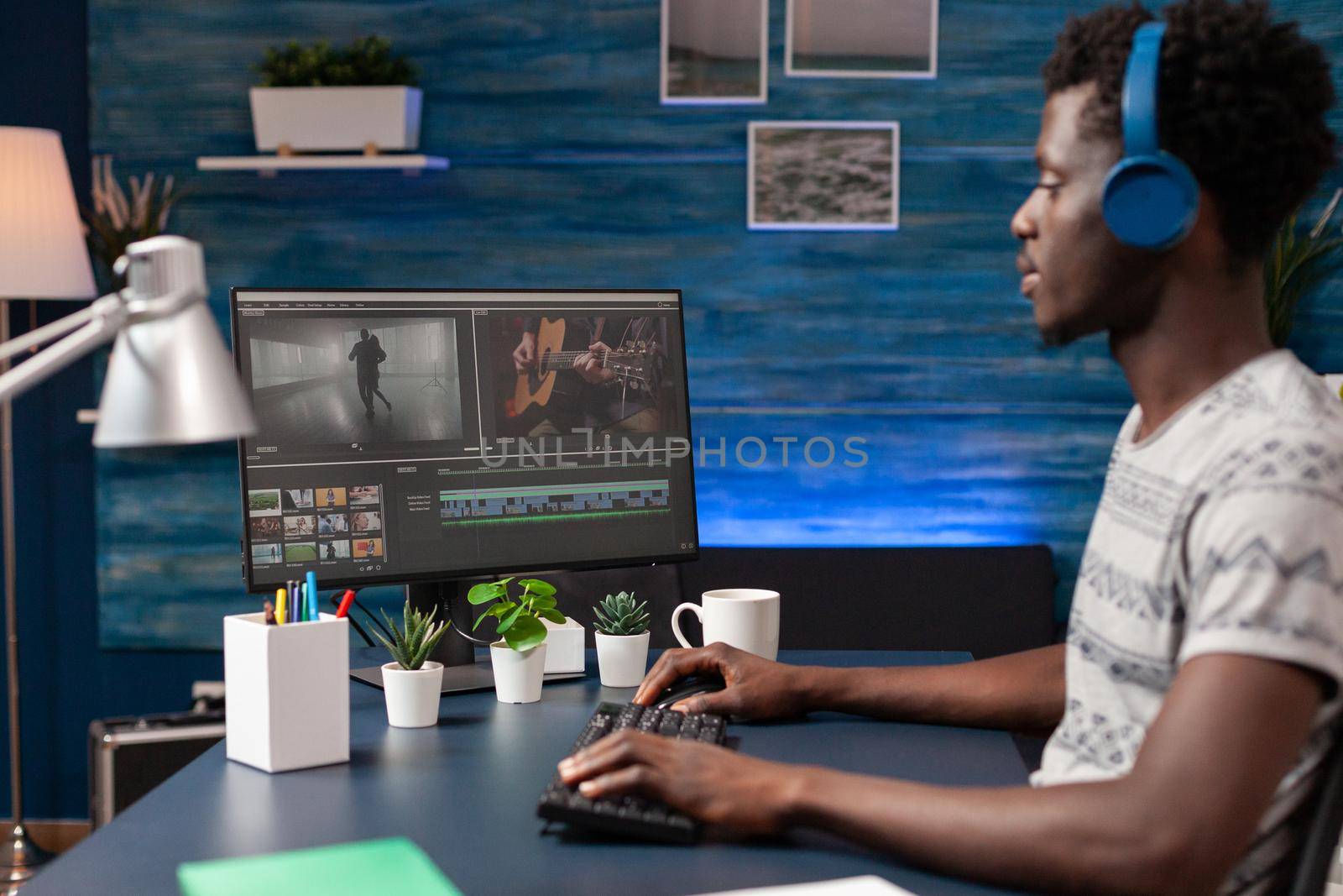 African american videographer editor retouching film montage editing visual effects using footage post production software. Young movie maker working remote from home at digital project