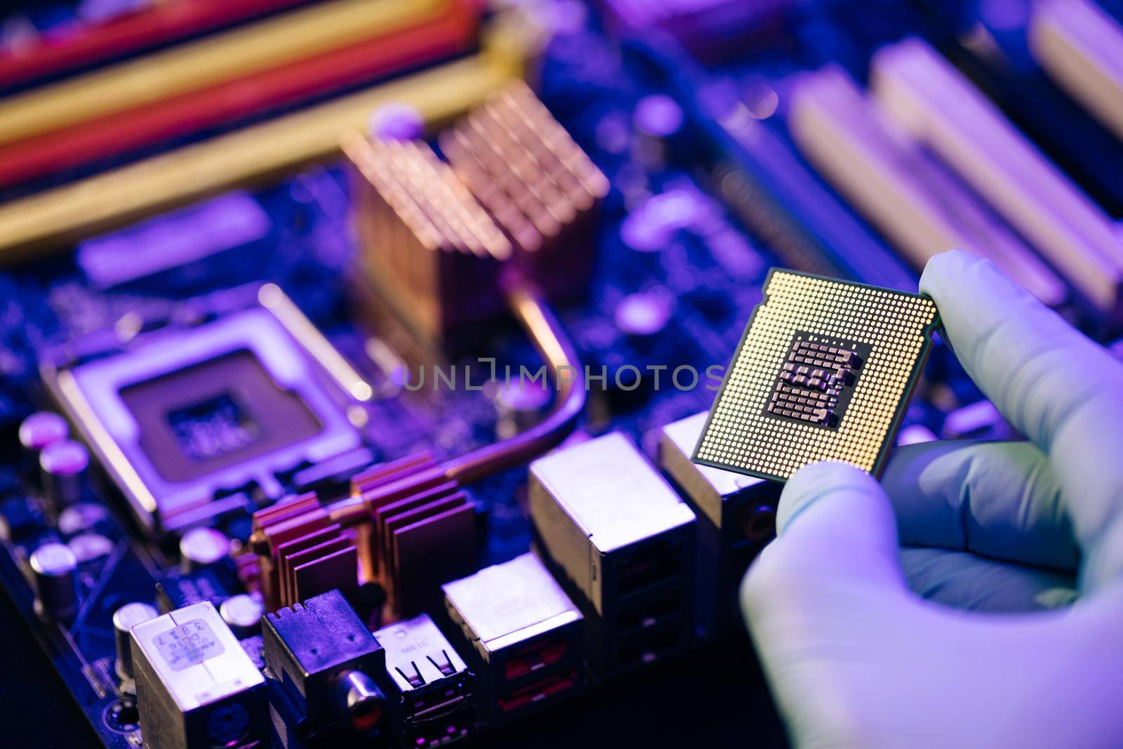 Laboratory technician holds a powerful processor in his hands. CPU computer processor. CPU socket of the computer's motherboard. Concept of computer, motherboard, hardware and technology