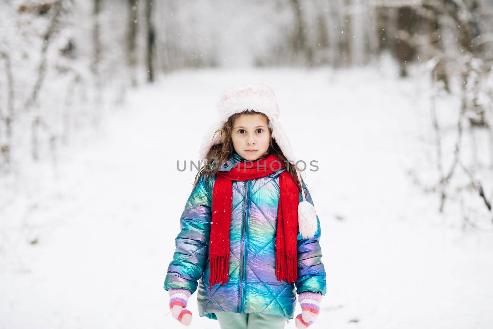 Walk in winter forest. Happy girl plays with a snow in winter day. Girl enjoys winter, frosty day. Winter girl smiling outdoor.