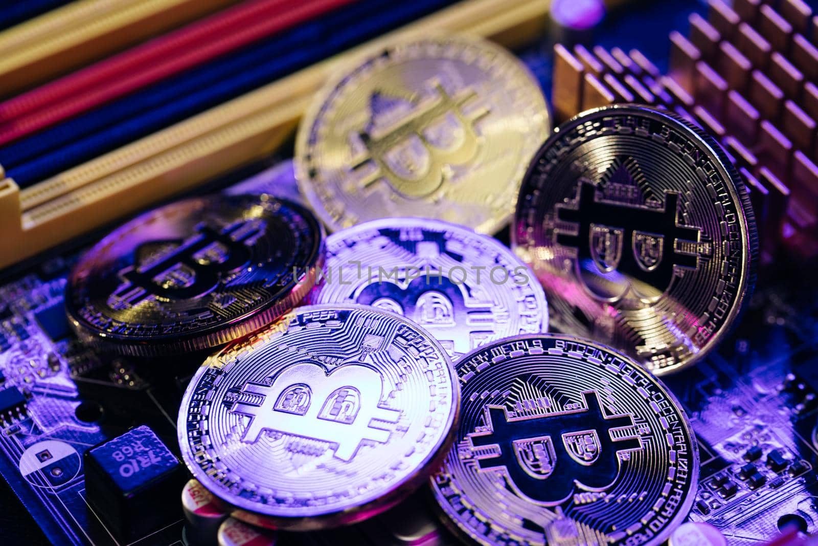 Close up shot of Bitcoins coins isolated on motherboard background. Crypto currency, bitcoin. BTC, Bit Coin. Blockchain technology, bitcoin mining.