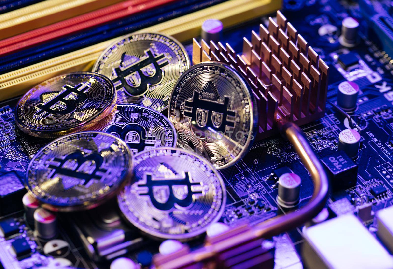 Blockchain technology, bitcoin mining concept. Lot Of Bitcoin Crypto currency Bitcoin BTC Bit Coin. Close up shot of Bitcoin coins isolated on motherboard background.