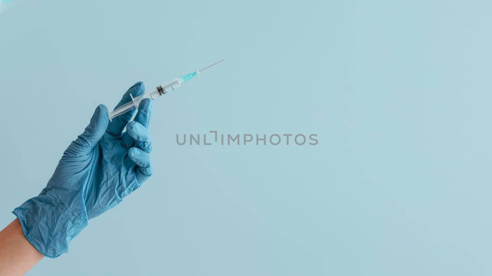 hand glove holding syringe. High resolution photo
