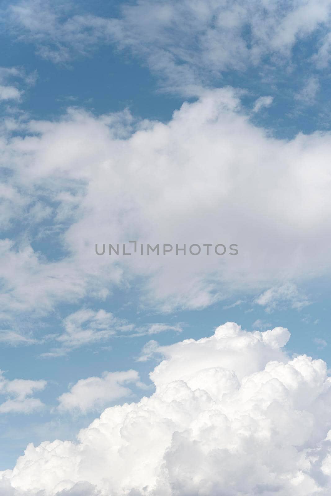 fluffy clouds sky vertical shot. High quality photo by Zahard