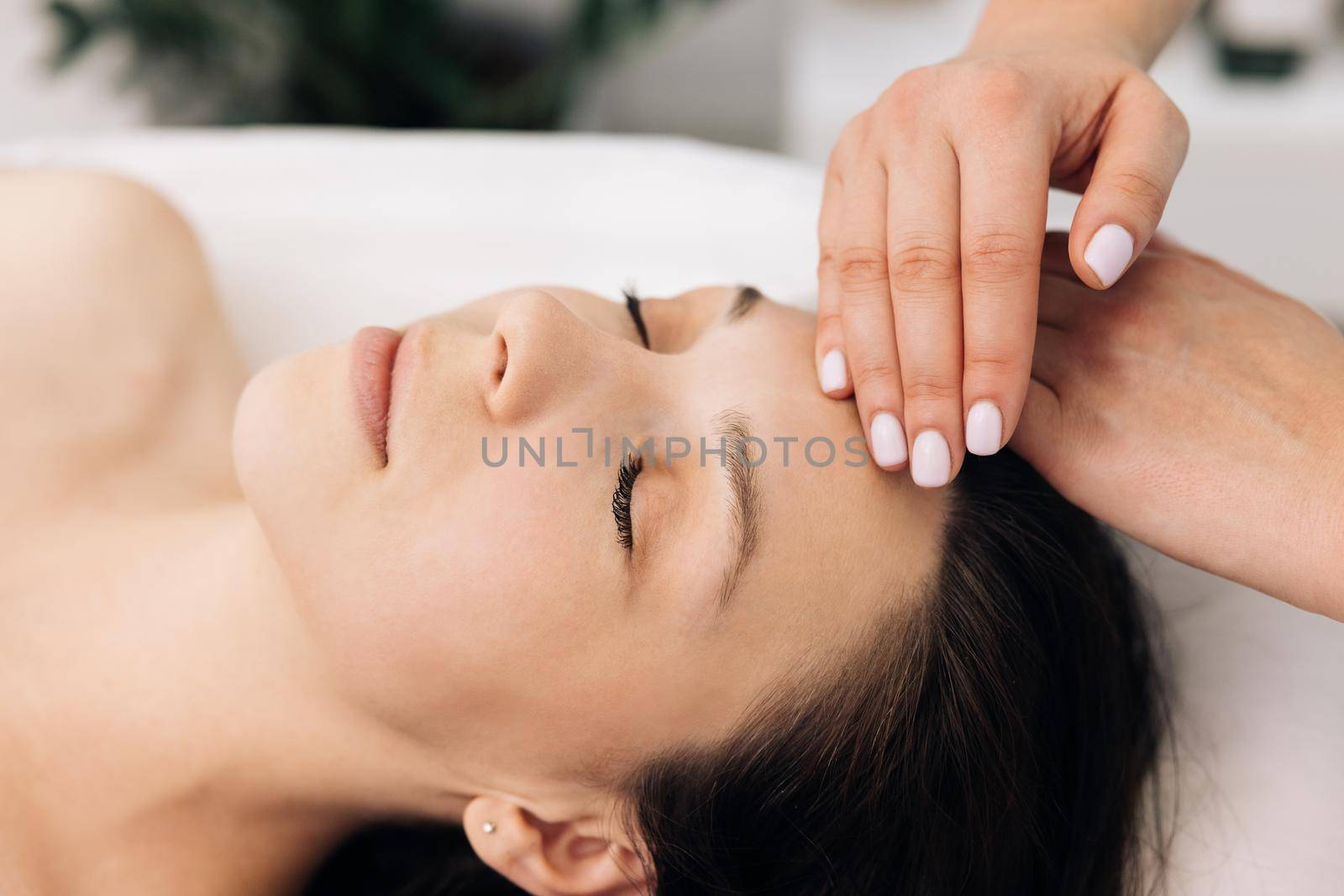 Body care, skin care, wellness, wellbeing, beauty treatment concept. Face Massage in beauty spa salon. Spa facial Massage. Beauty Treatments by uflypro