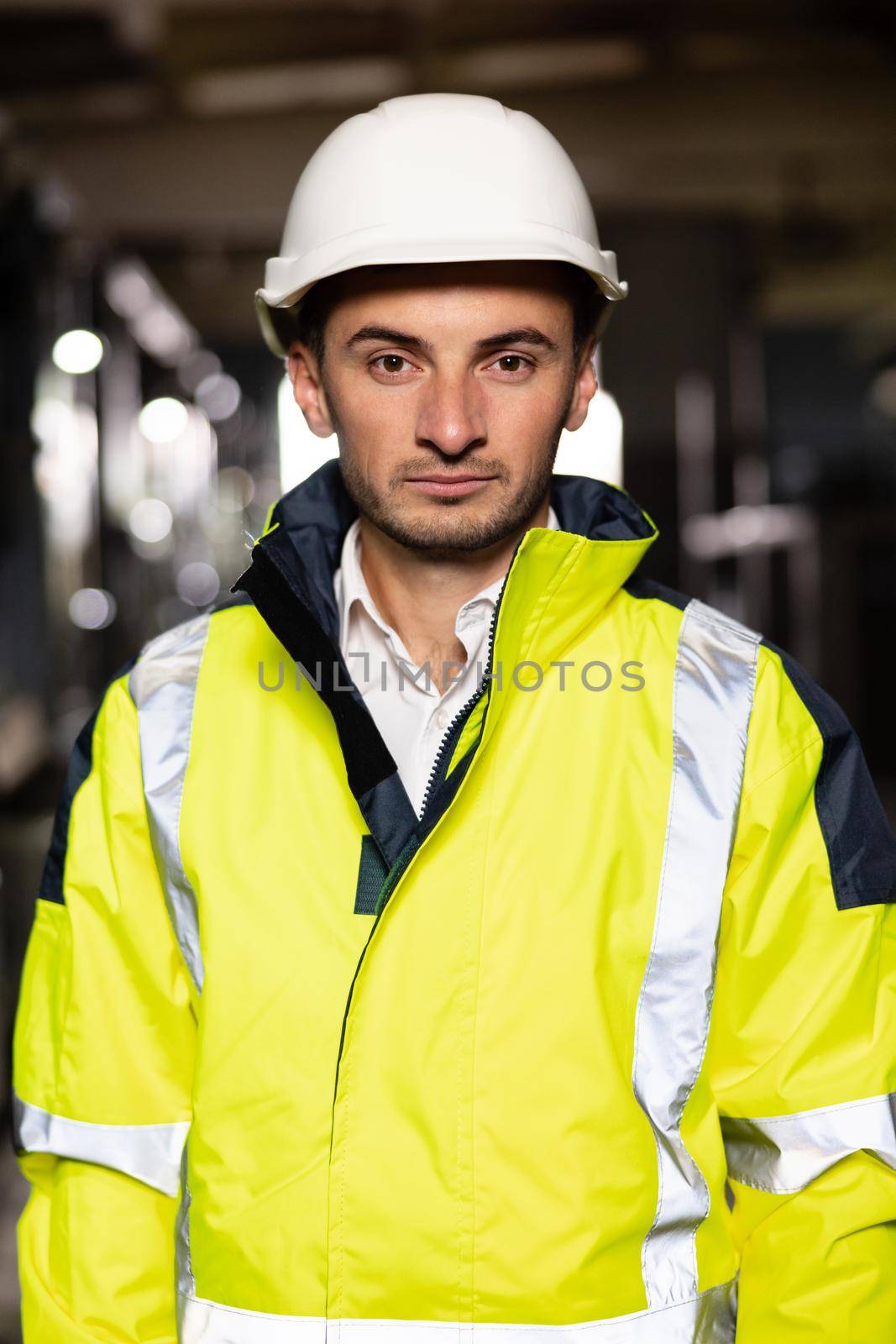 Caucasian business people in hard hat or safety wear. Professional male industry engineer specialist. Portrait of a frontline essential worker in a warehouse by uflypro