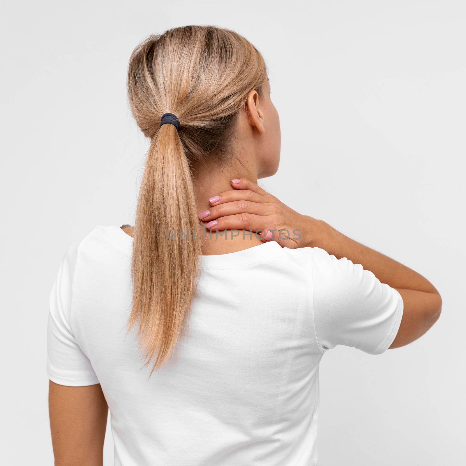 back view woman with neck pain. High resolution photo