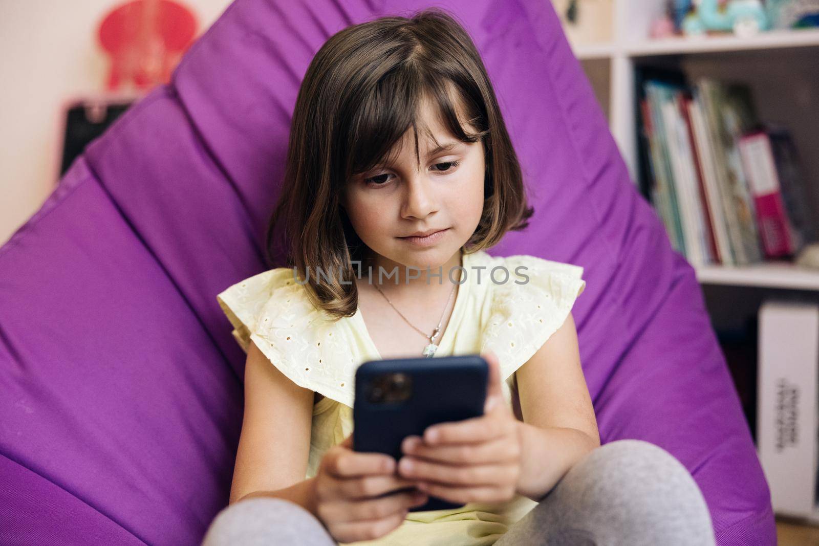Kid Using Smartphone, Child Browsing Internet on Smart Phone, Teenager Girl Communicating with Parents, Technology on Device. Girl using mobile phone or chat.