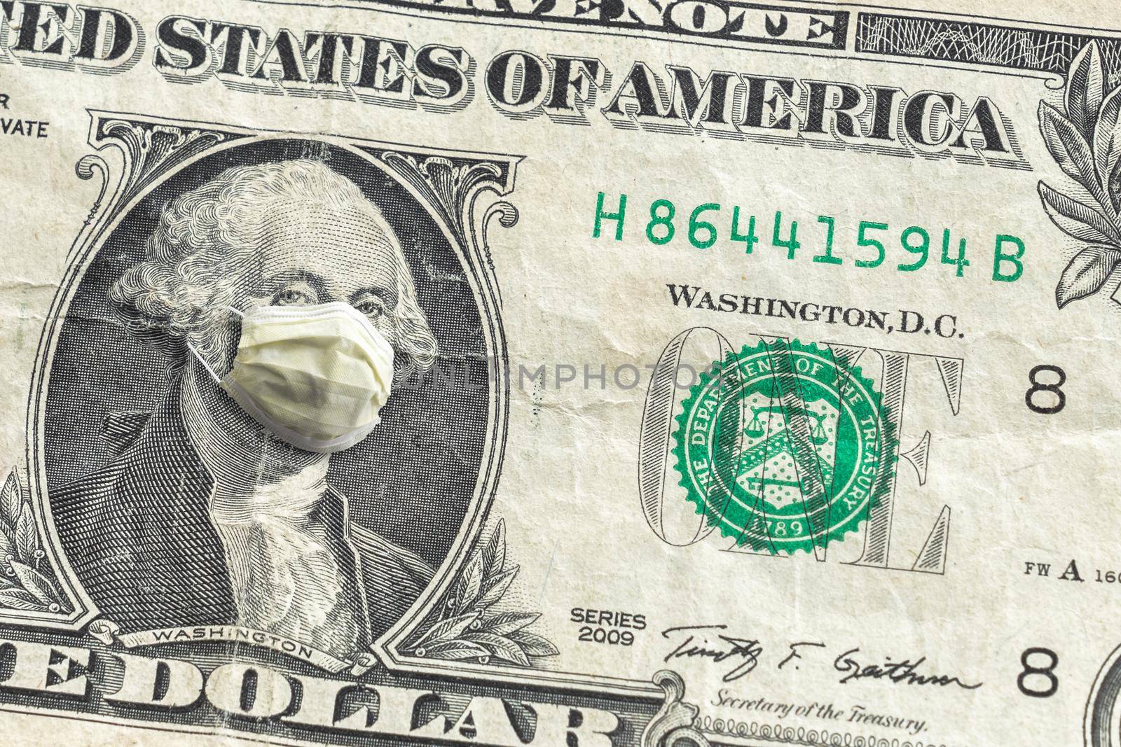 United States paper currency one dollar bill with George Washington wearing yellow face covering doctor mask due to COVID-19 pandemic making a great finance or economic background amidst the crisis.