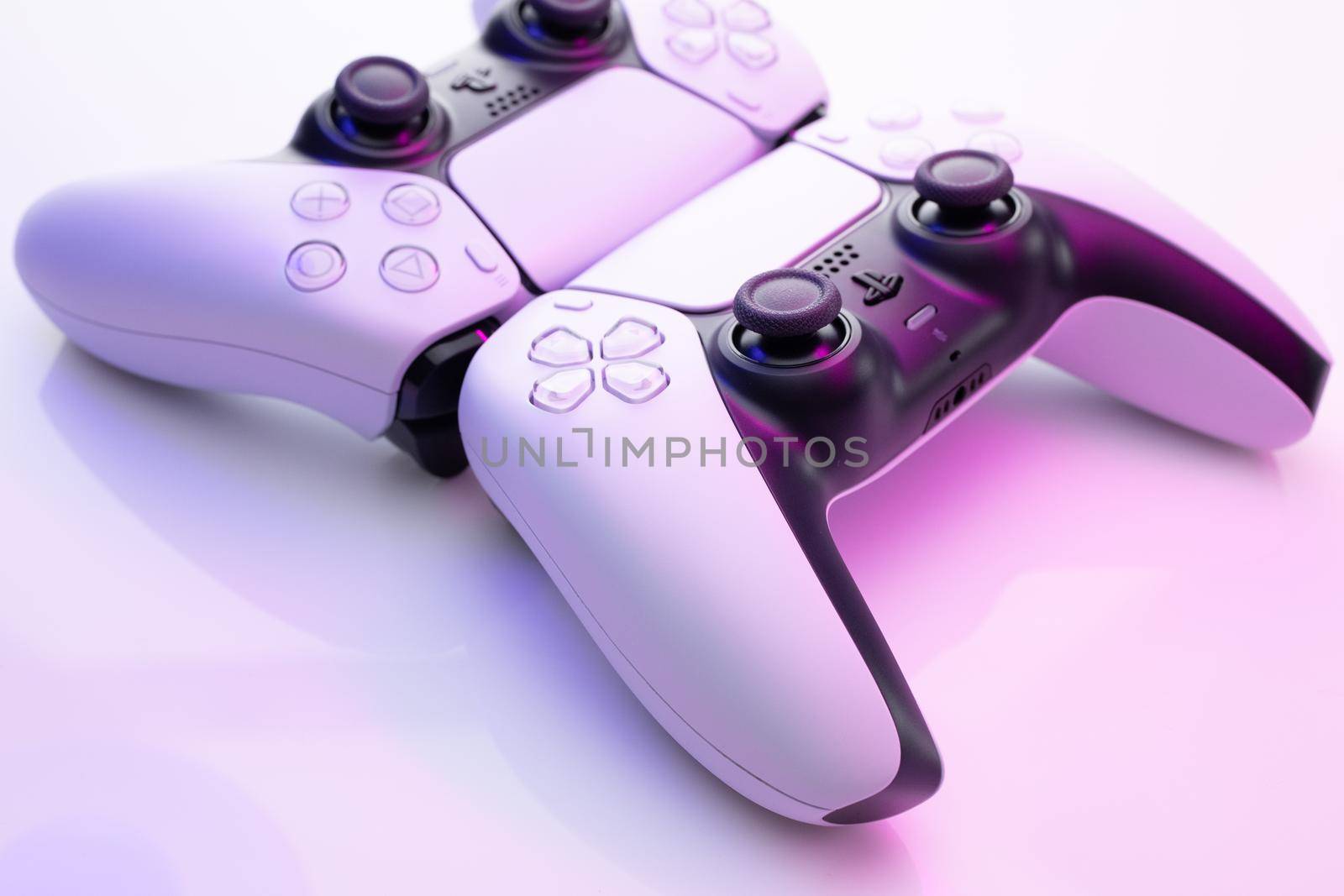 Lviv, Ukraine - February 27 2021: Two joysticks from Sony PlayStation 5 TV game console. White controllers from revolutionary TV game box by uflypro