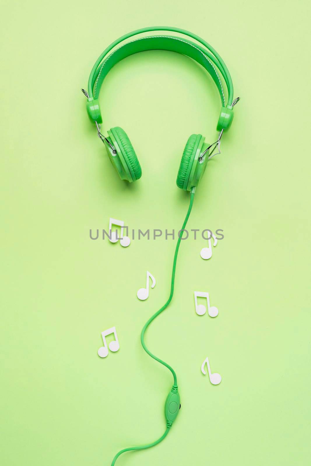 green headphones with white musical notes. High quality photo by Zahard