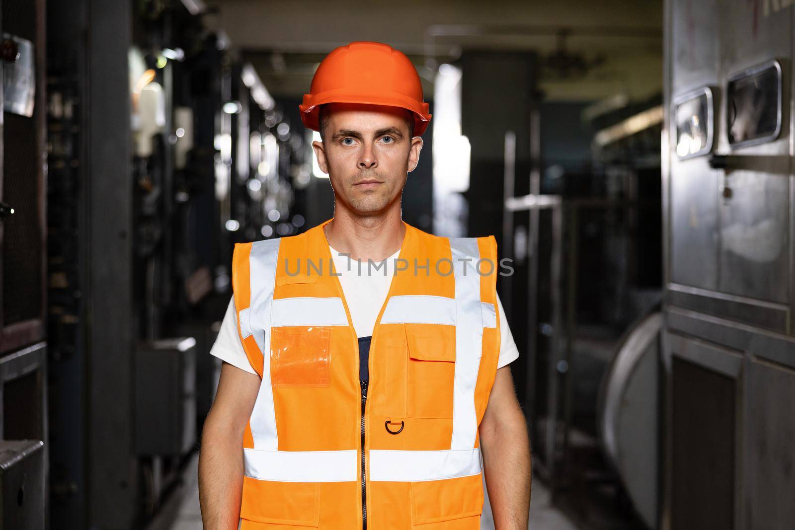 Male Inspection Person in Protective Hardhat Wear. Engineer Planning Manufacture Work. Blueprint of Confident Technical Foreman or Attractive Workman Mechanic near Modern Machine Tool Indoors by uflypro