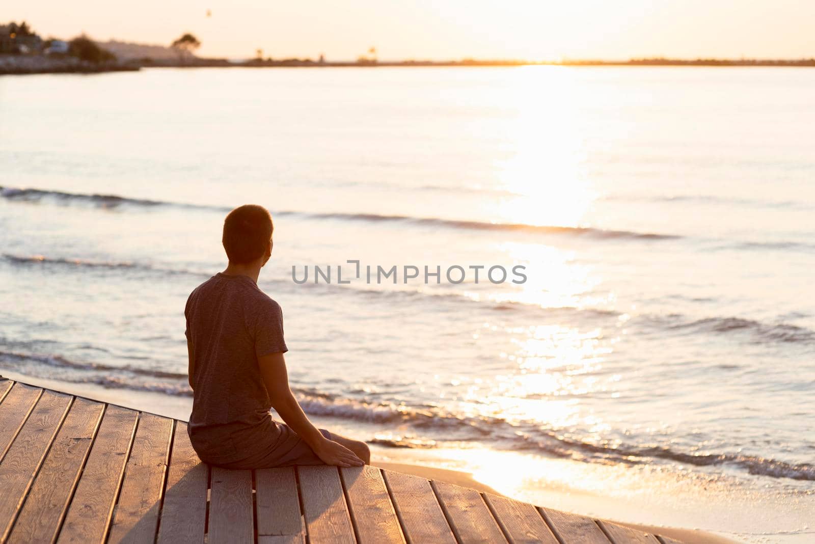 man meditating beach. High resolution photo