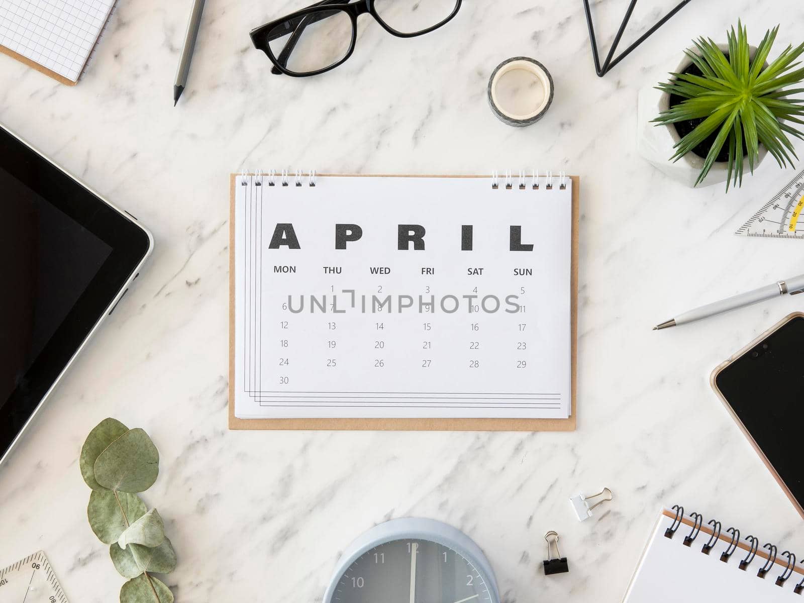 top view desk april calendar. High resolution photo