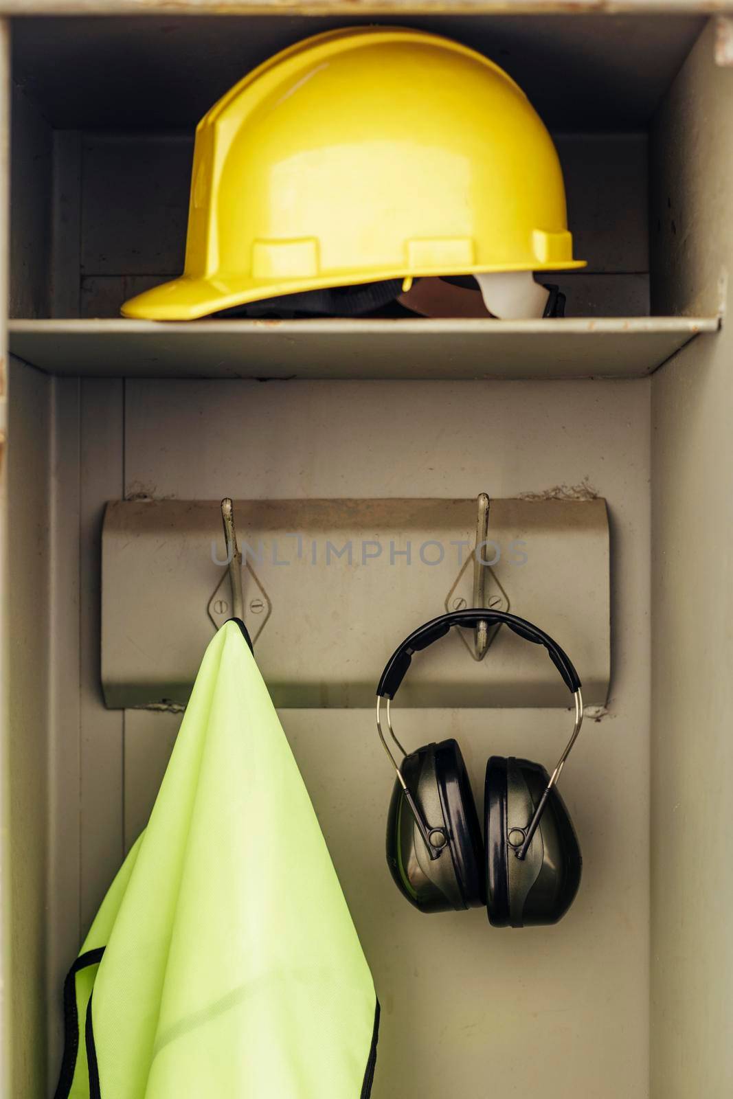 front view hard hat headphones hanging closet. High resolution photo