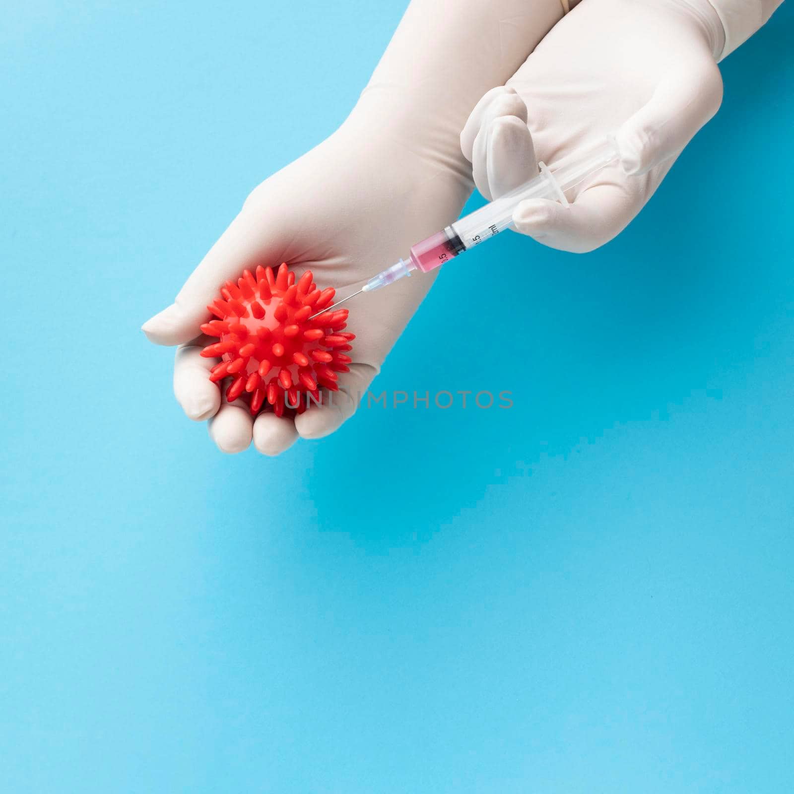 top view hand holding virus syringe with vaccine. High resolution photo