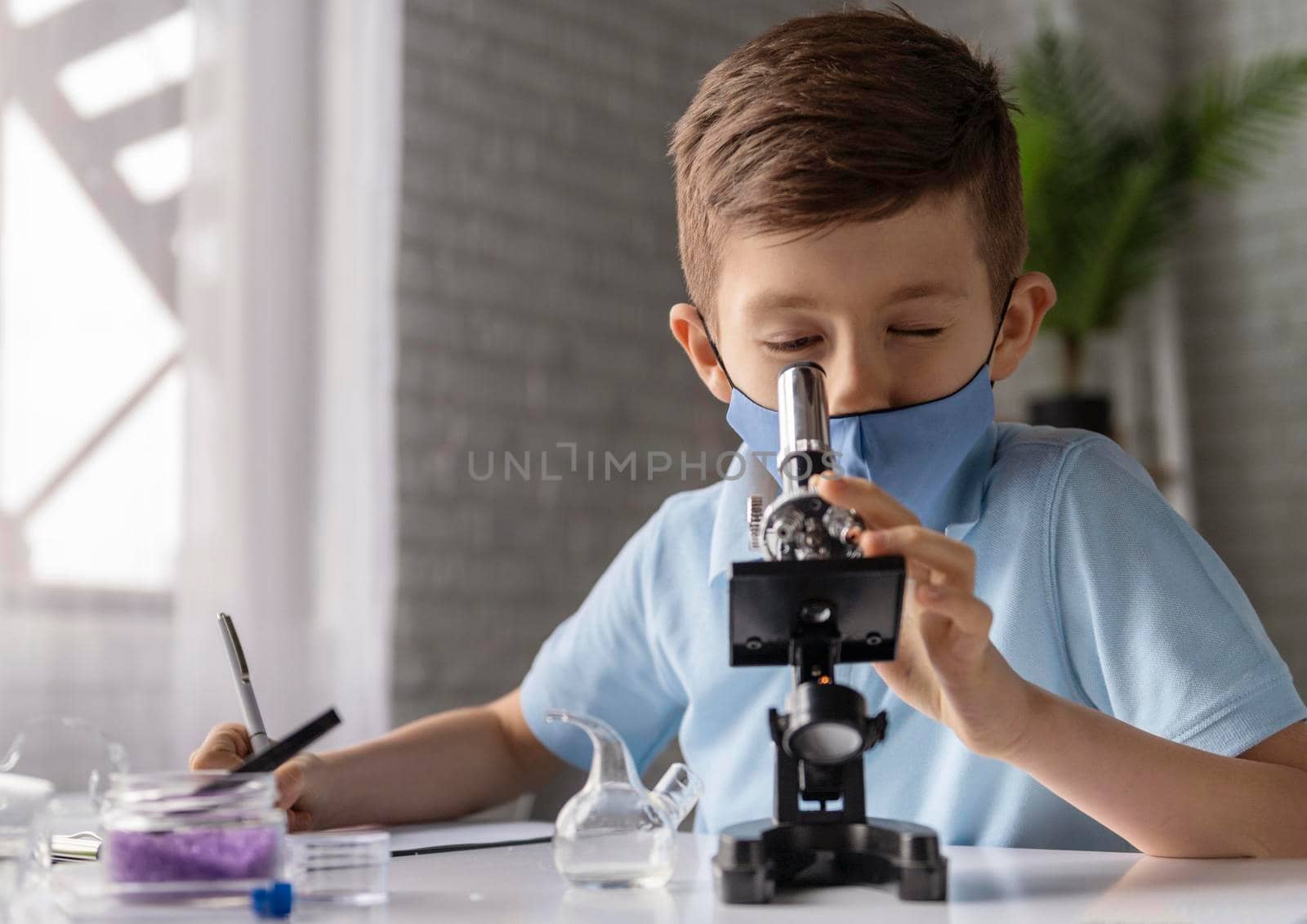 medium shot kid looking through microscope. High resolution photo