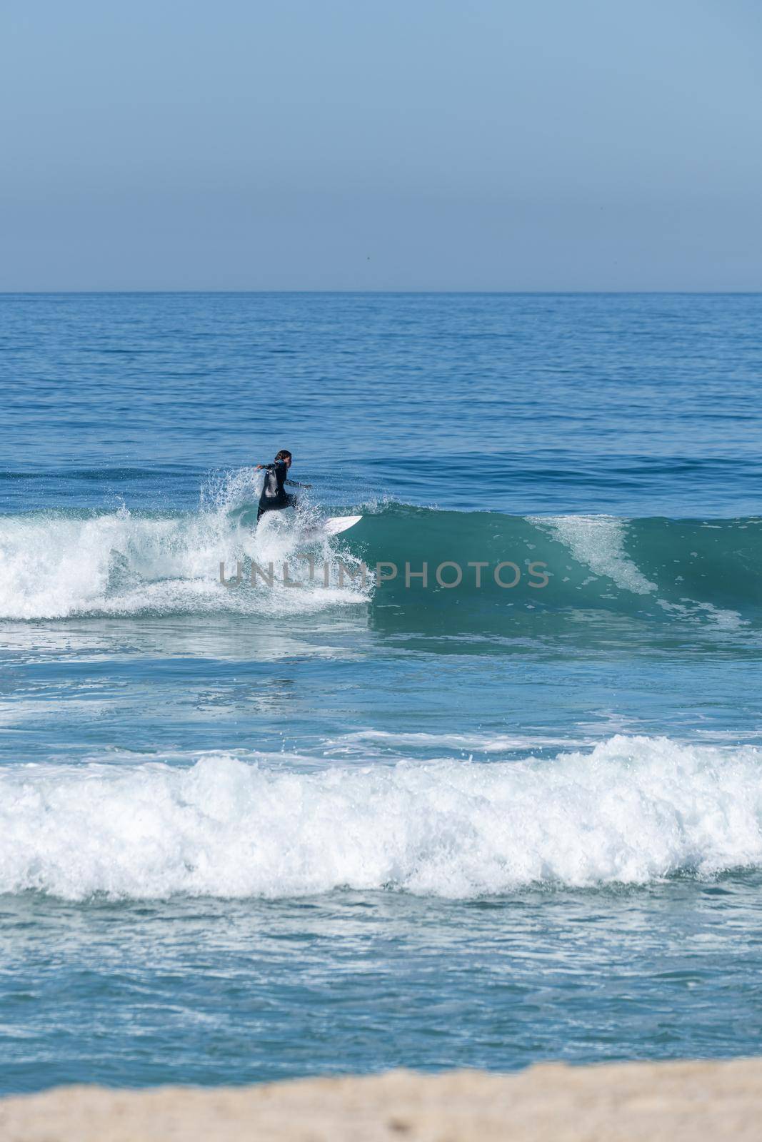 Soul surfer girl riding a wave in Furadouro beach, Ovar - Portugal.