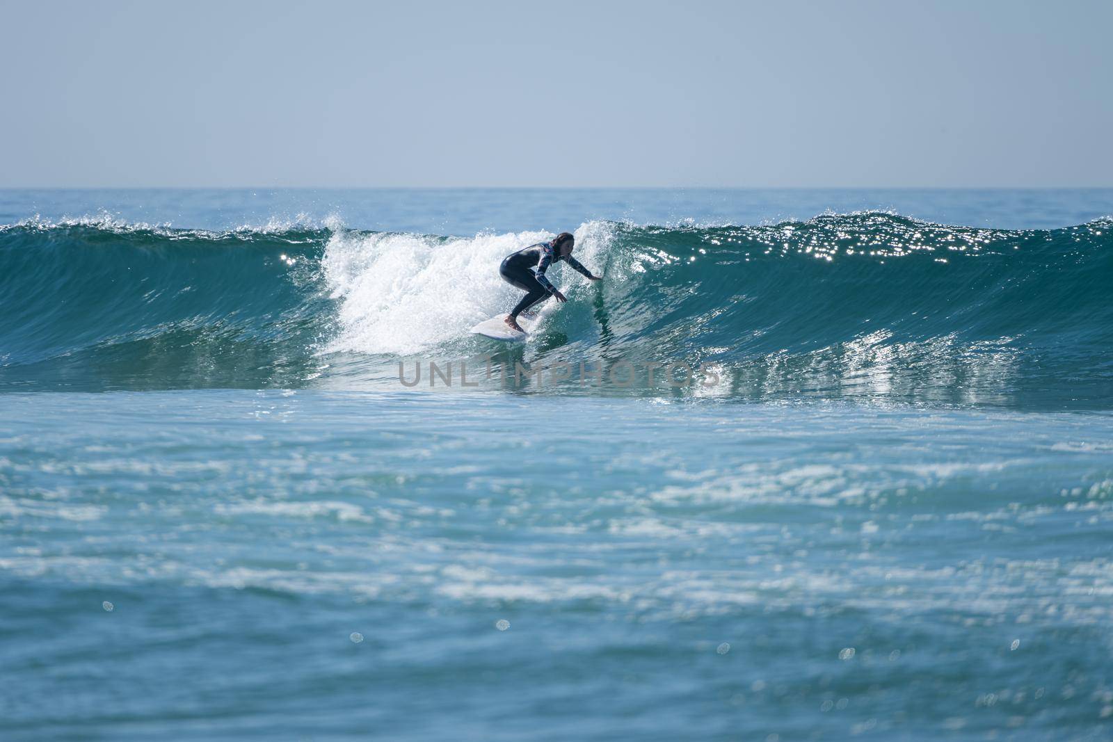 Soul surfer girl riding a wave in Furadouro beach, Ovar - Portugal.