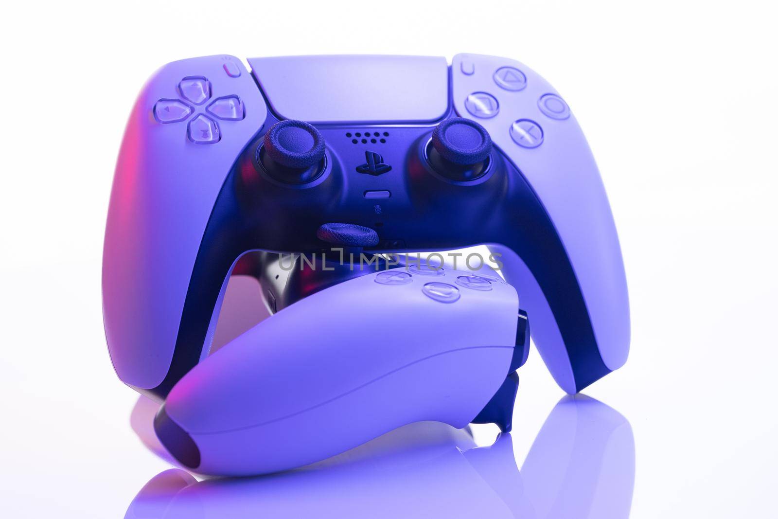 Lviv, Ukraine - February 27 2021: Two joysticks from Sony PlayStation 5 TV game console on a white background. Close up view of 2 controllers from new console. by uflypro