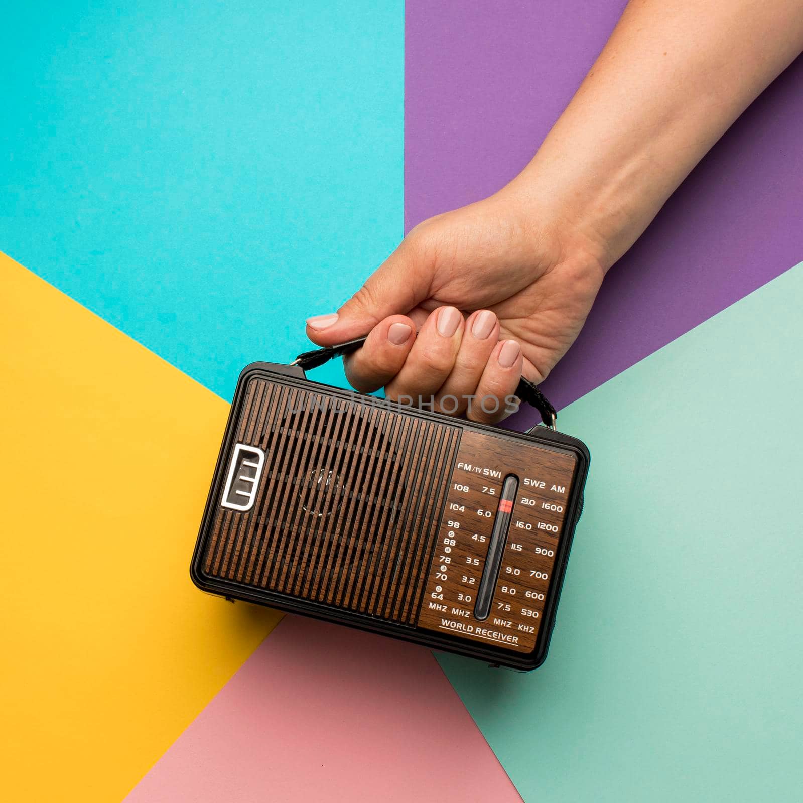 person holding retro broadcast radio receiver. High resolution photo