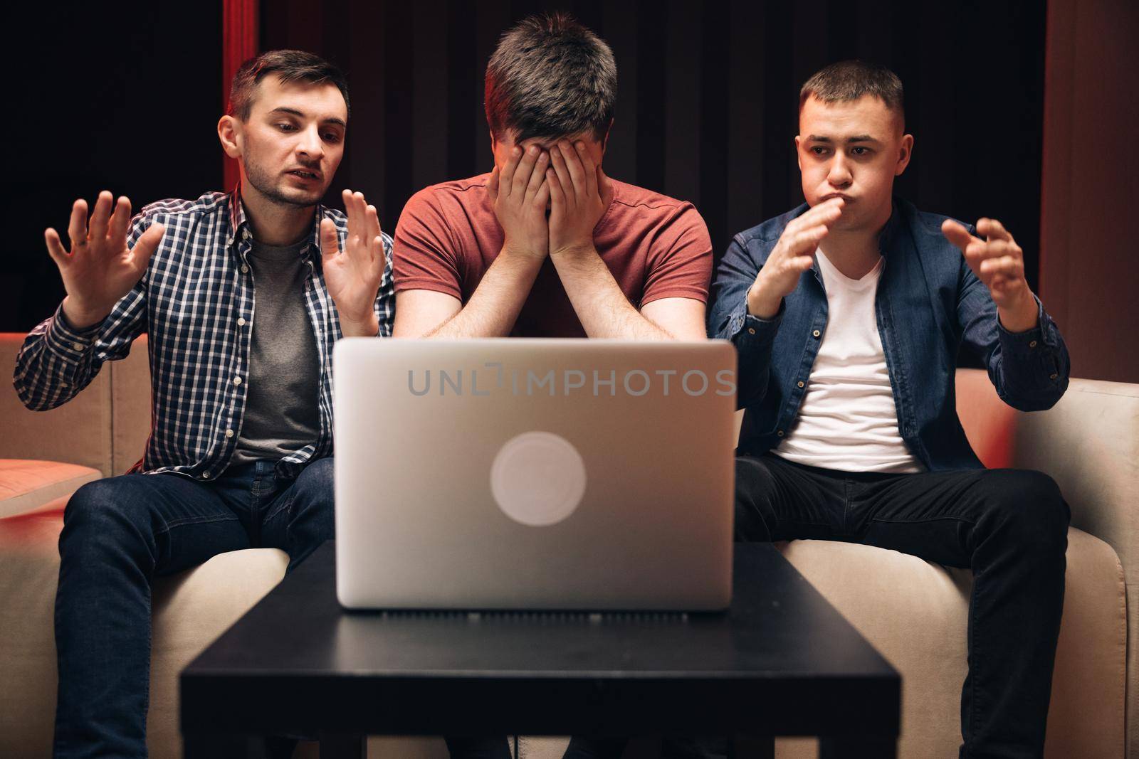 Men fans buddies supporters cheering celebrating victory goal score support winning team. Men watching football in streaming on laptop. Male friends watching online football game match at laptop.