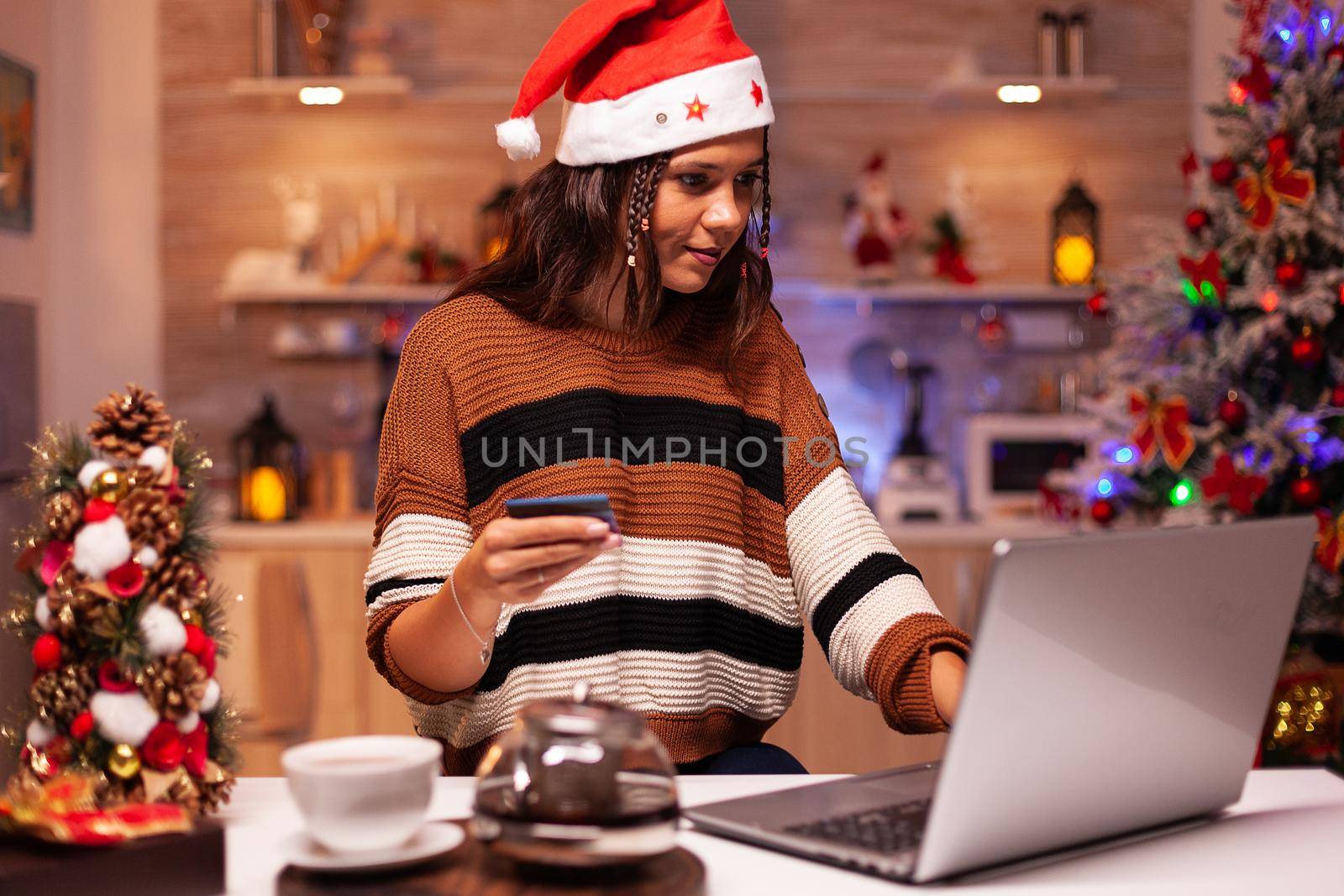 Joyful adult doing online shopping for christmas by DCStudio