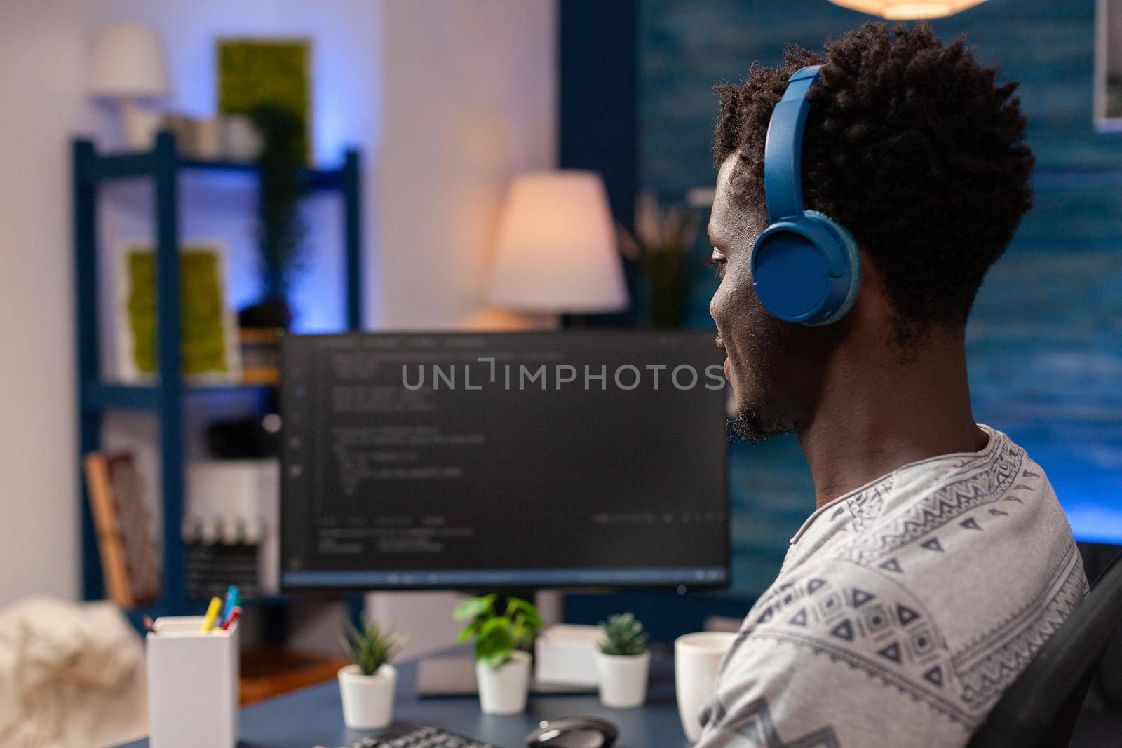 African american programmer with headset programming website code by DCStudio