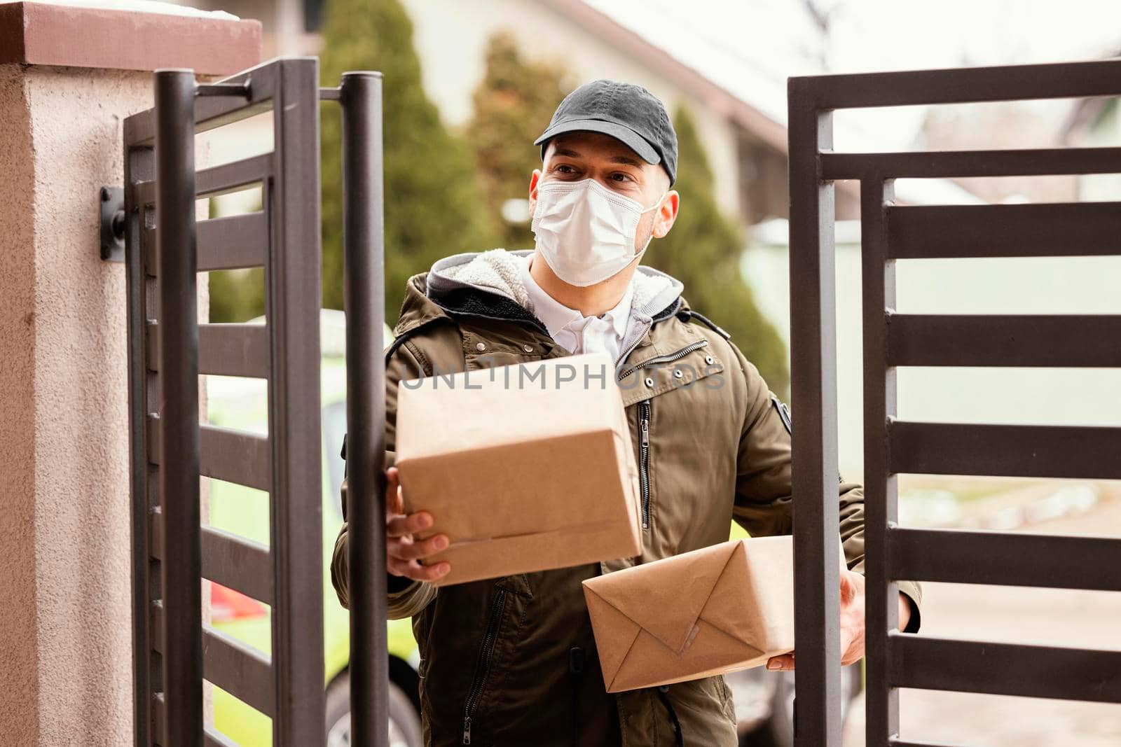 delivery man package wearing mask. High resolution photo