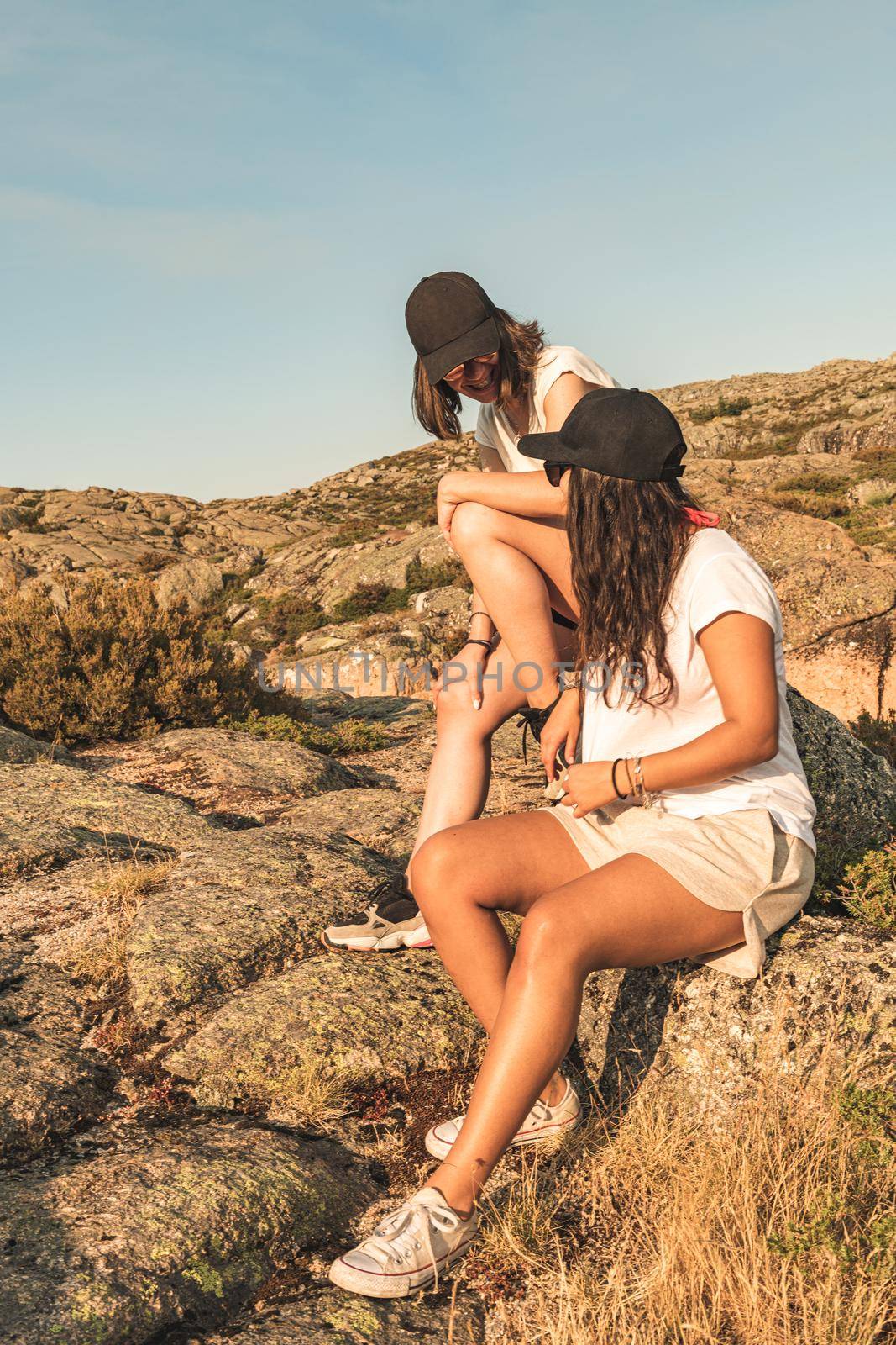 Two woman traveler watching sunset direction on mountain landscape.