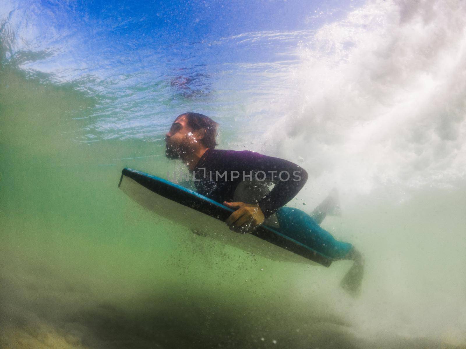 Bodyboarder duck diving a wave in Furadouro beach, Ovar - Portugal