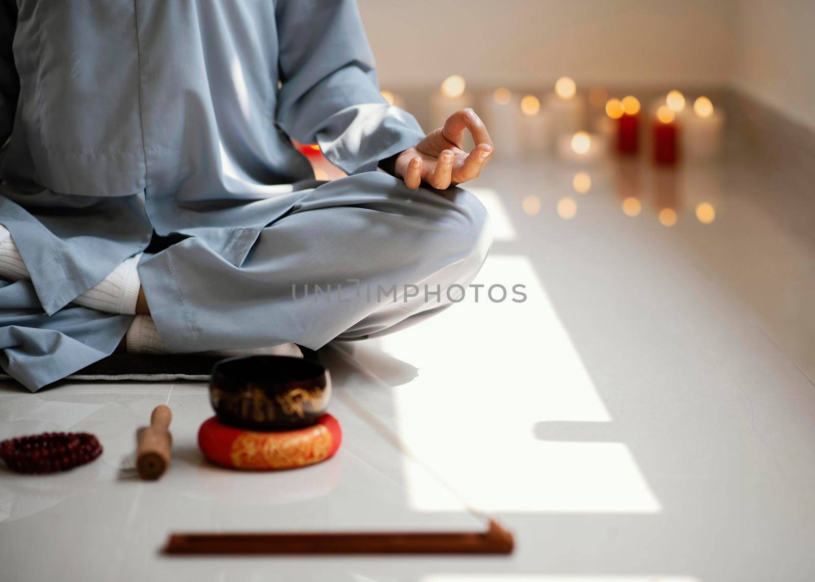 front view woman meditating with incense candles. High resolution photo
