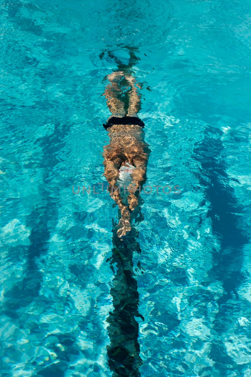 high angle male swimmer swimming water pool. High resolution photo