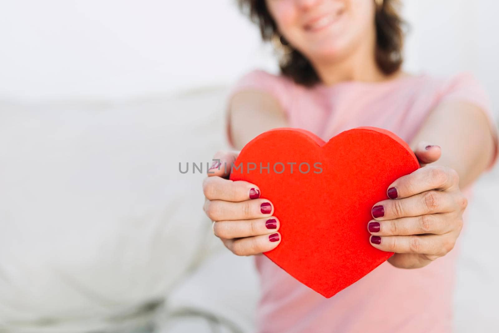 crop woman showing heart shaped box. High resolution photo